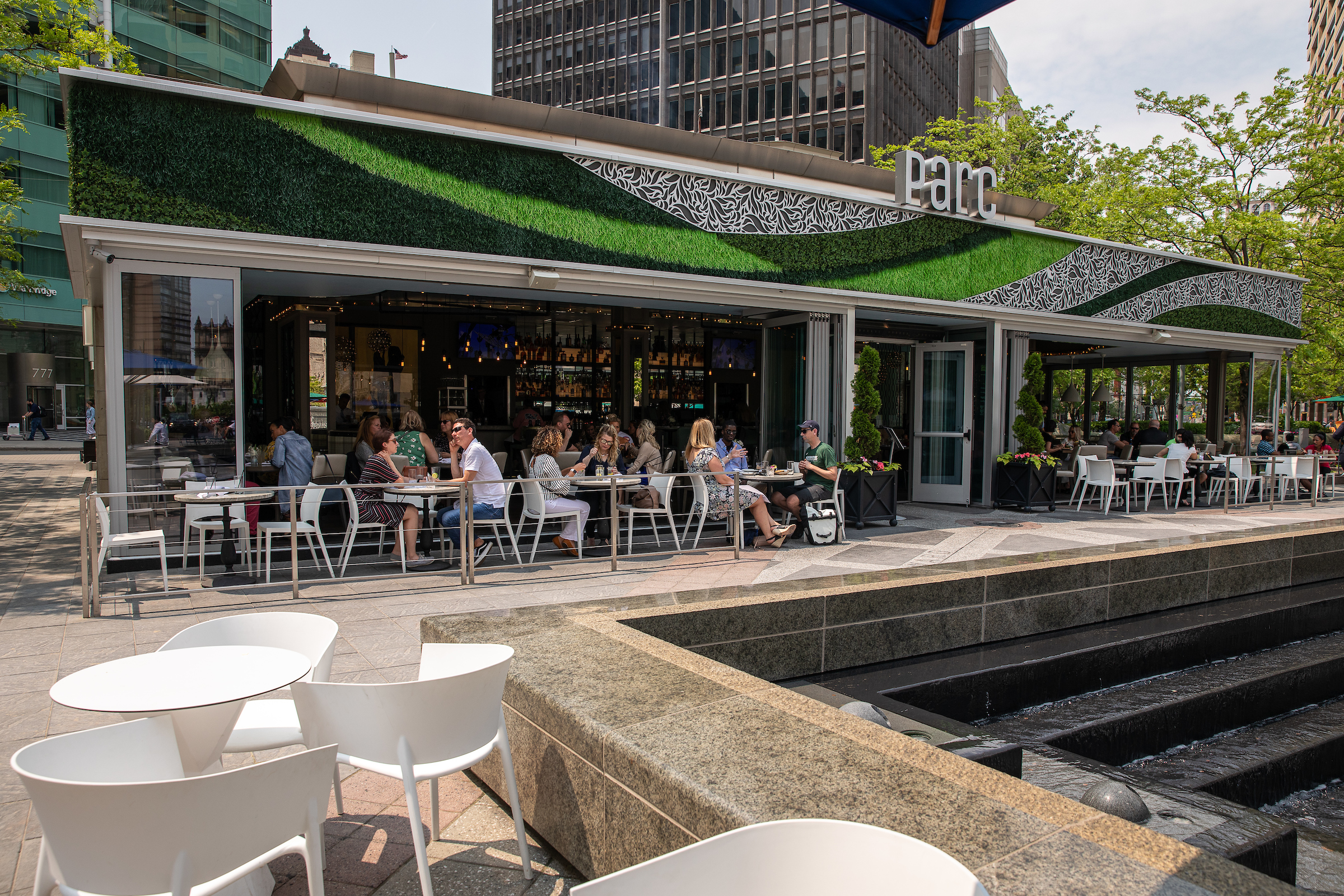 customers sit at tables at parc in Campus Martius. 