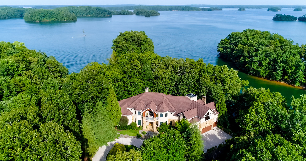 An aerial photo of a large house on a huge lake.