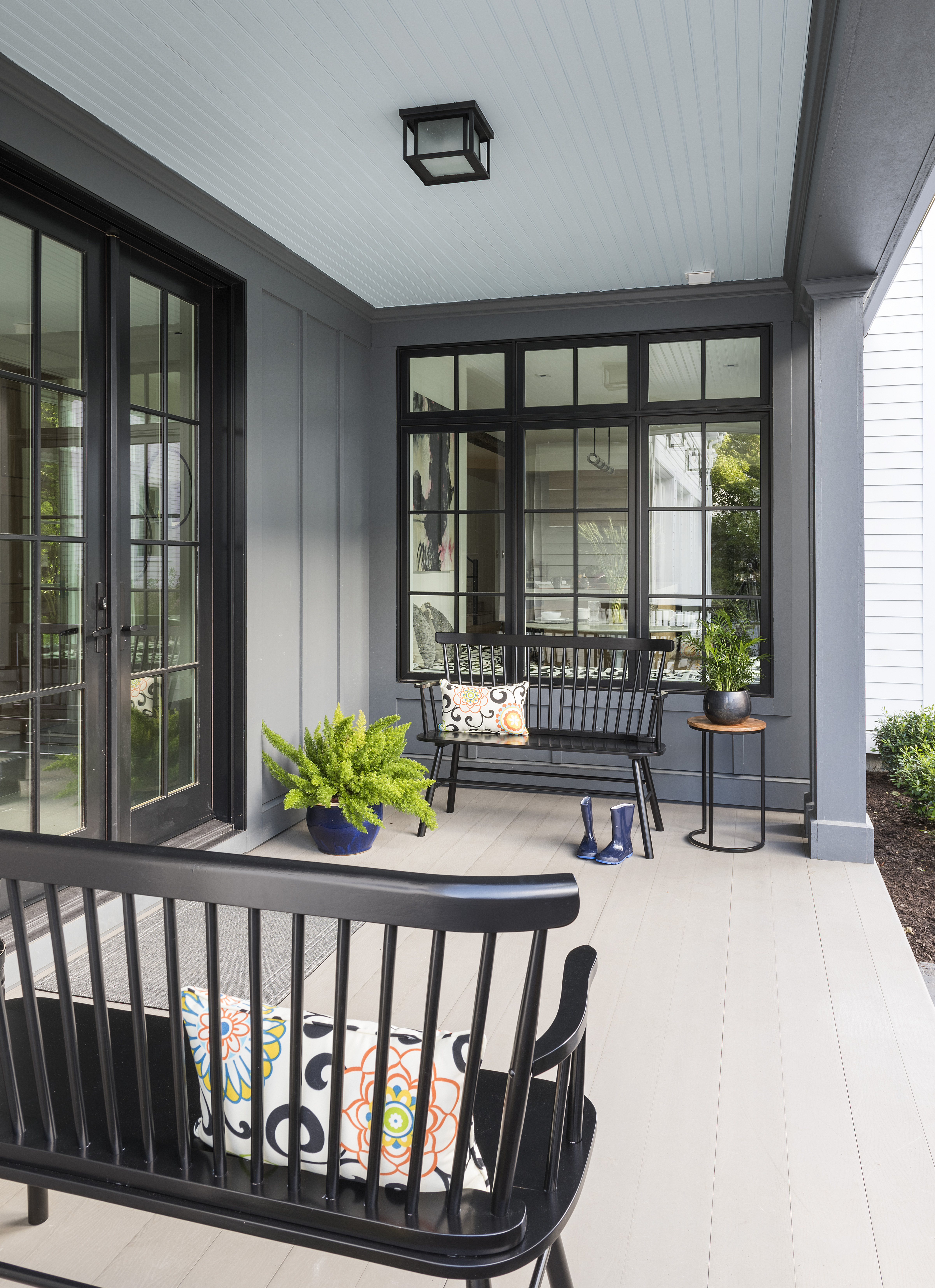 Side porch with black benches