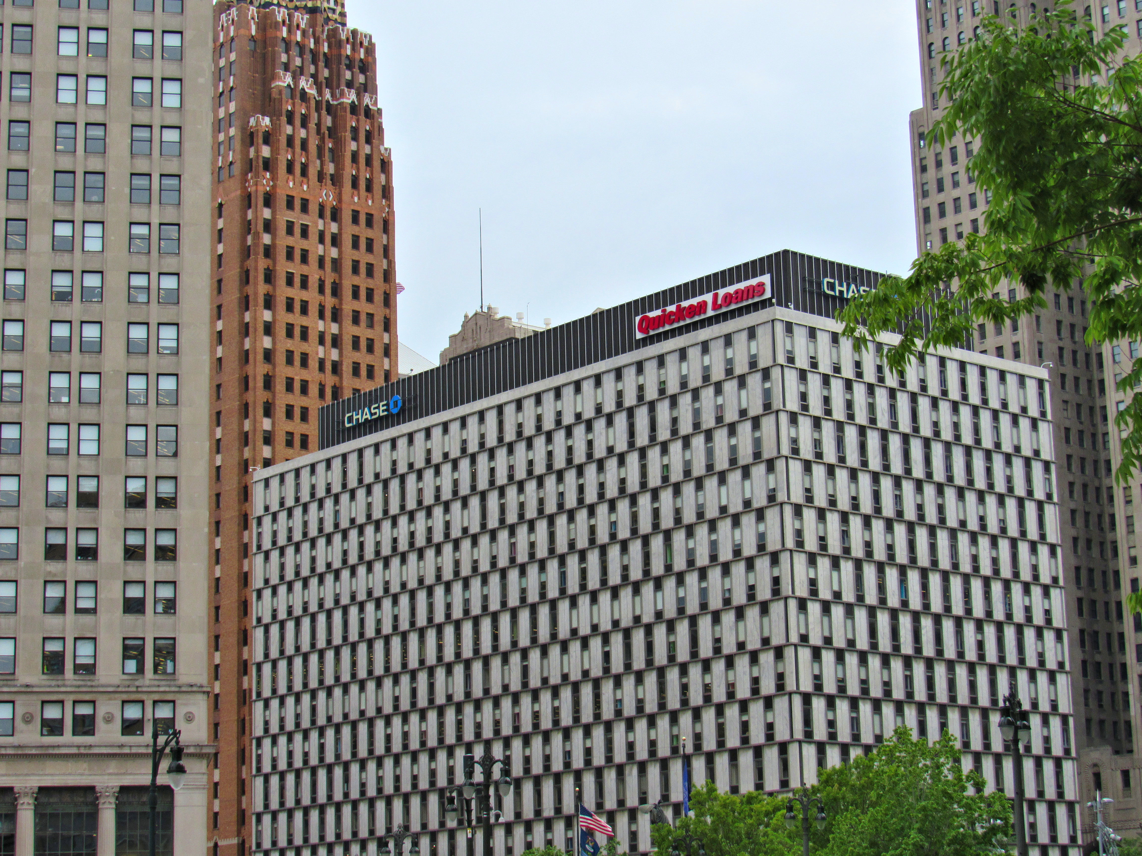 A multi-story rectangular building with alternating windows white cladding. The top of the building has the words “Quicken Loans.”