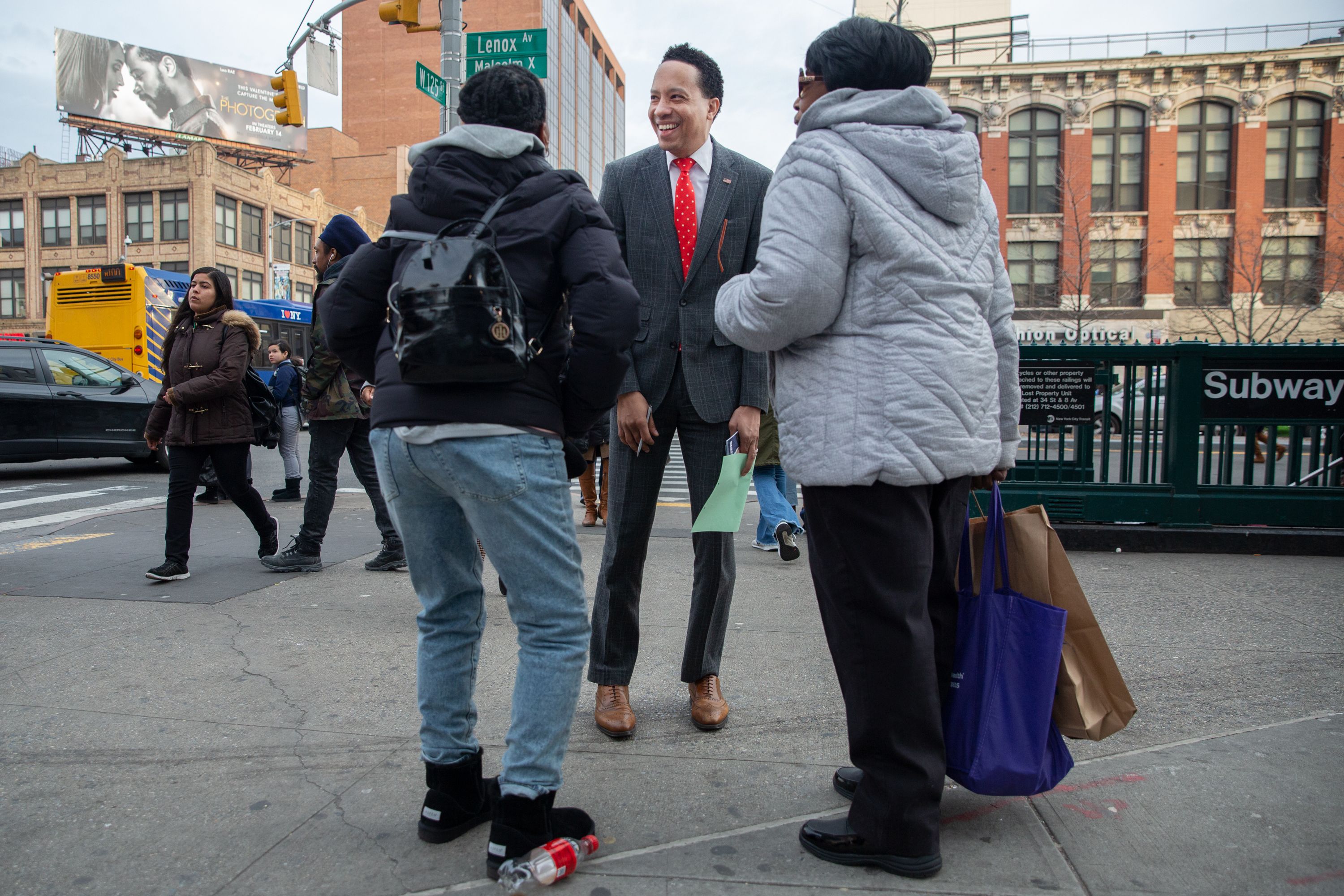 James Felton Keith speaks with voters in Central Harlem while campaigning for Congress.