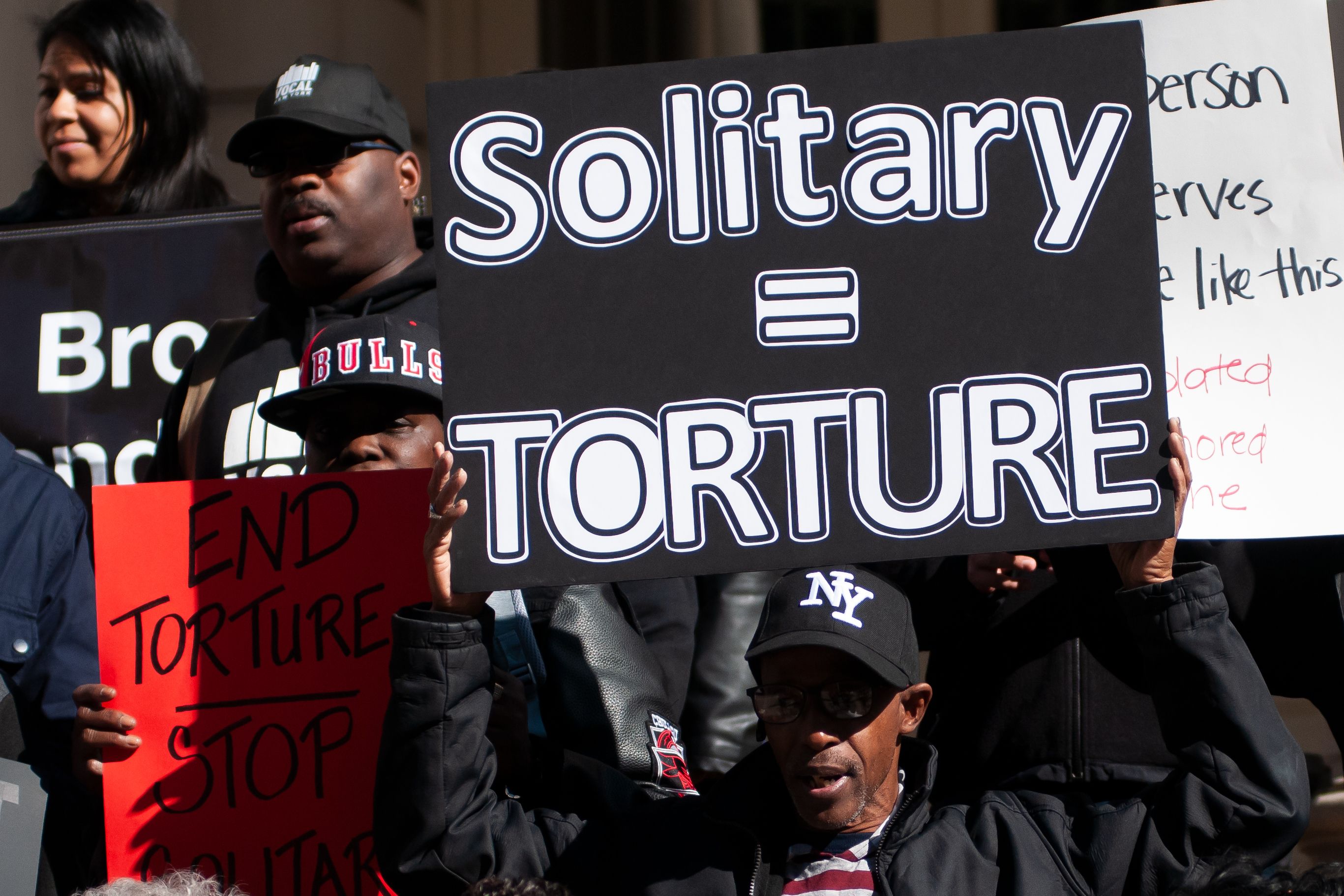 Criminal justice reform activists call for a plan to end the use of solitary confinement during a press conference on the steps of City Hall, Oct. 21, 2019.