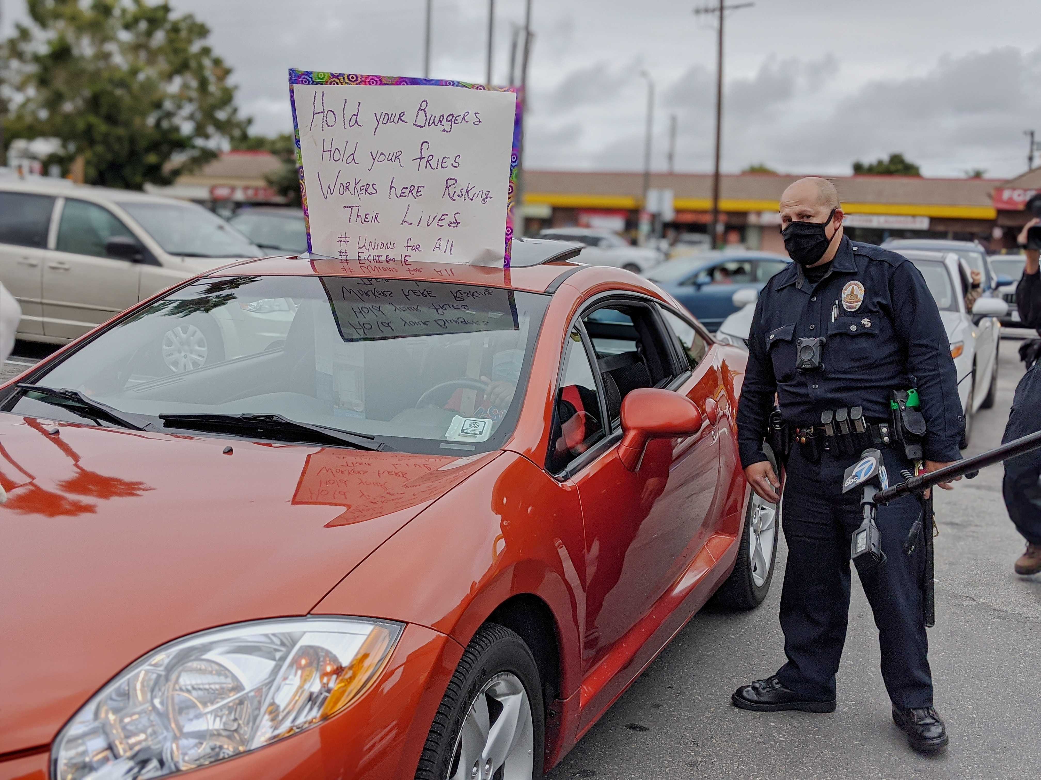 Police attempt to break up protest at South LA McDonald’s on April 6, 2020