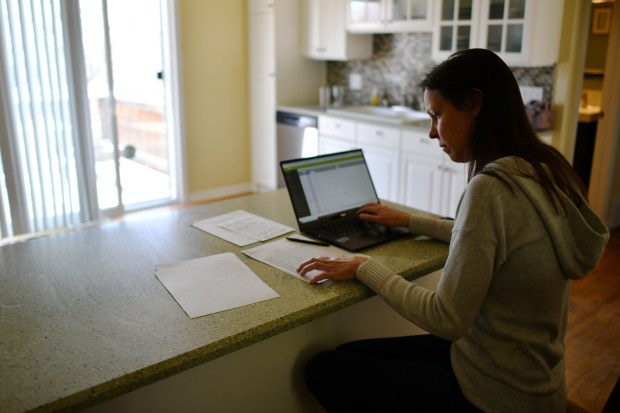 Erin Reiner grades her students’ projects at her home in Lakewood on Thursday, March 26, 2020.