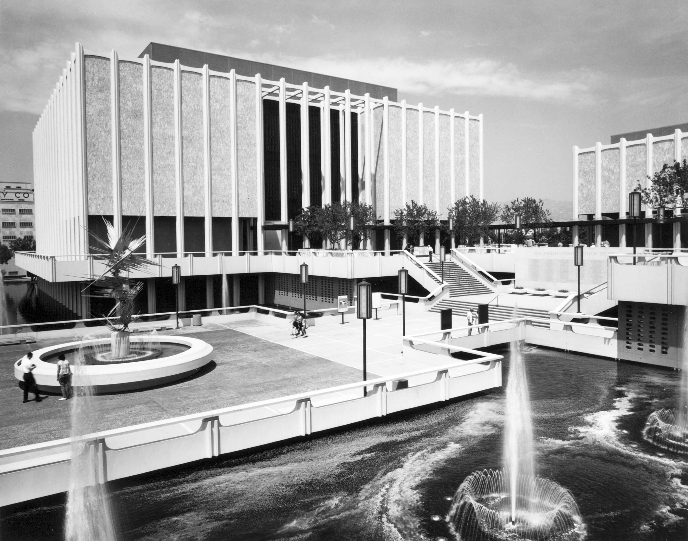 A black and white image of a museum complex with buildings that appear to float over pools of water.