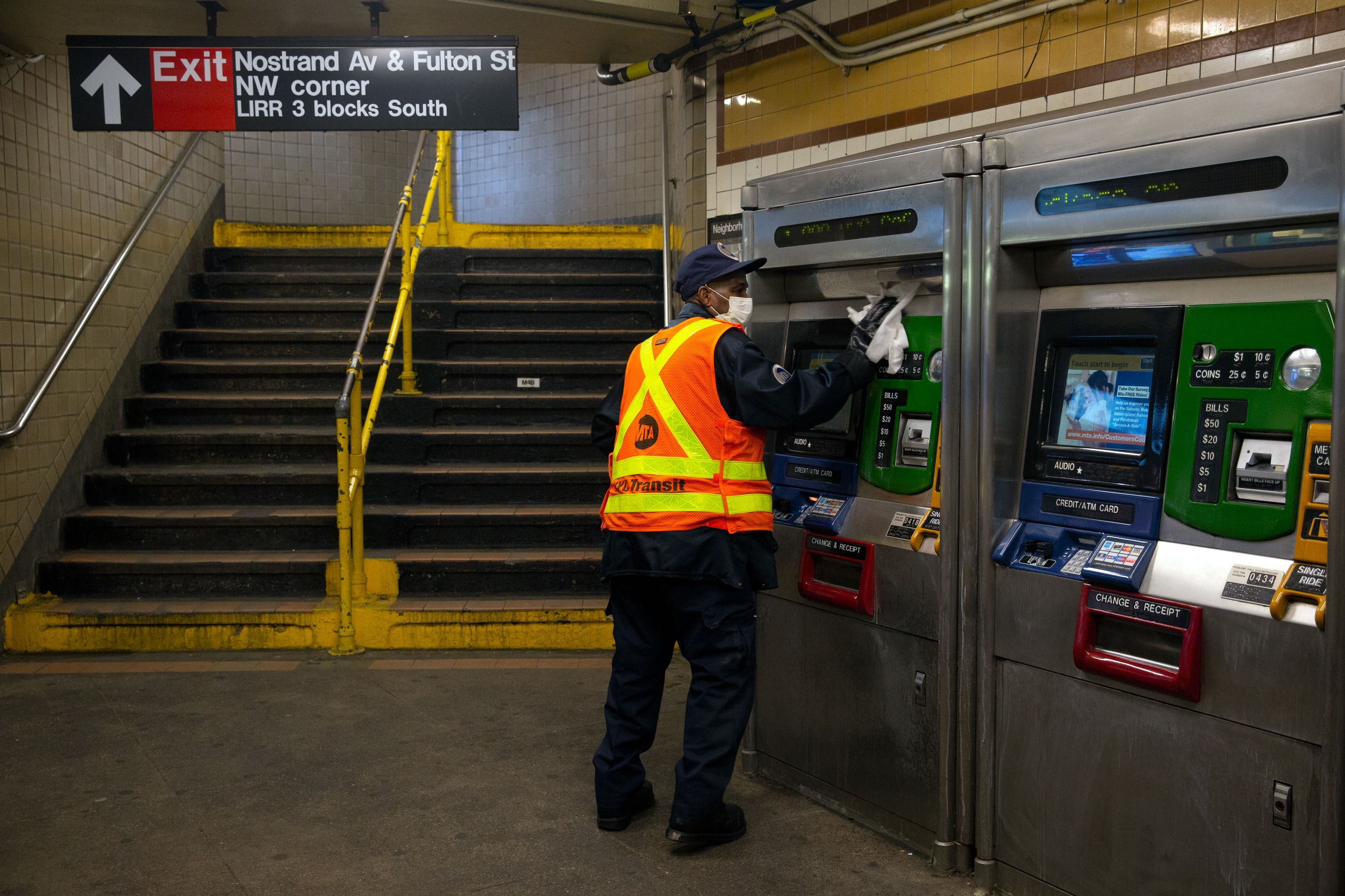 An MTA workers disinfects the Nostrand Avenue station during the coronavirus outbreak.