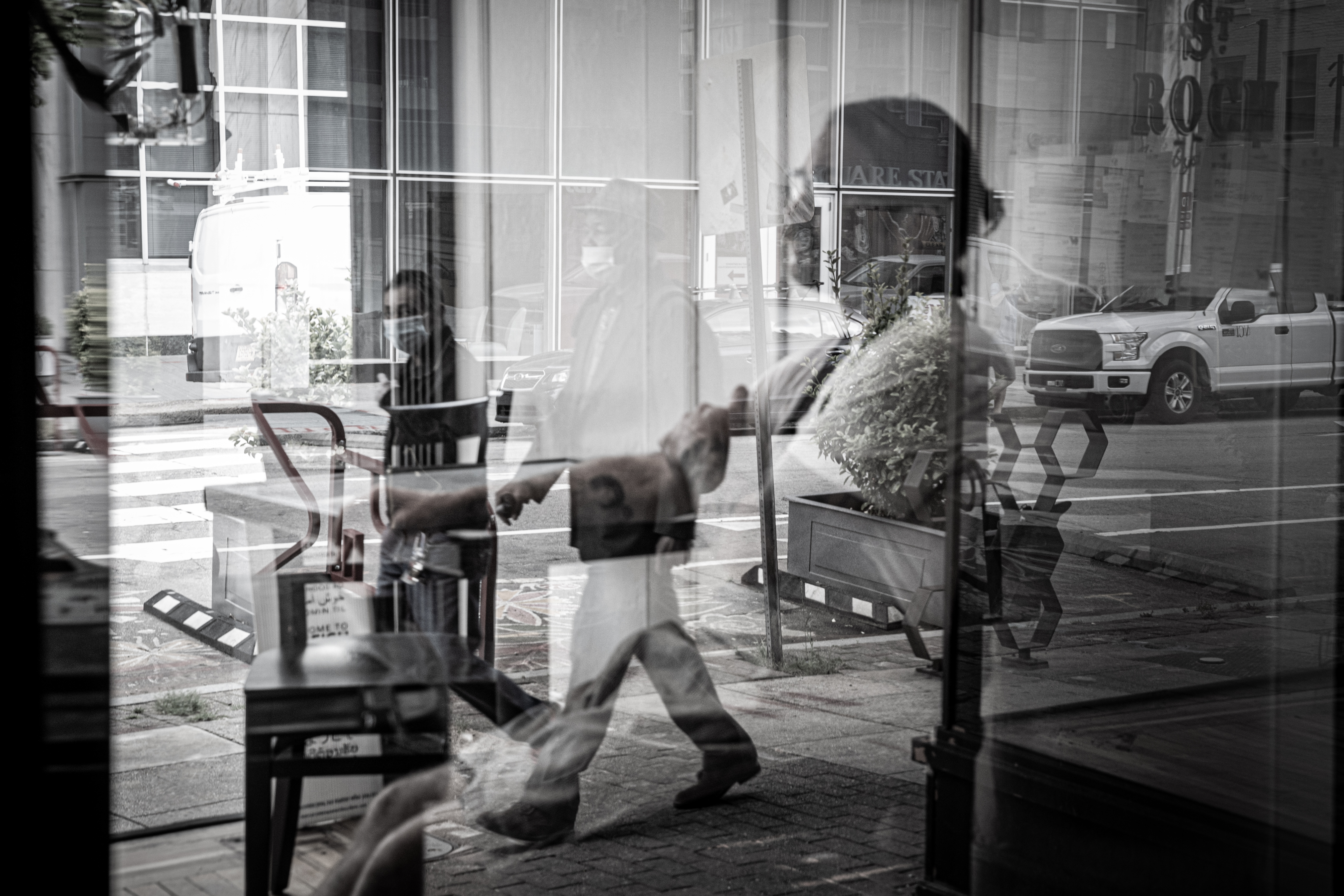 Chef Sunny Gerhart sits alone in the glass windows at the entrance  of his restaurant, St., Roch, in downtown Raleigh