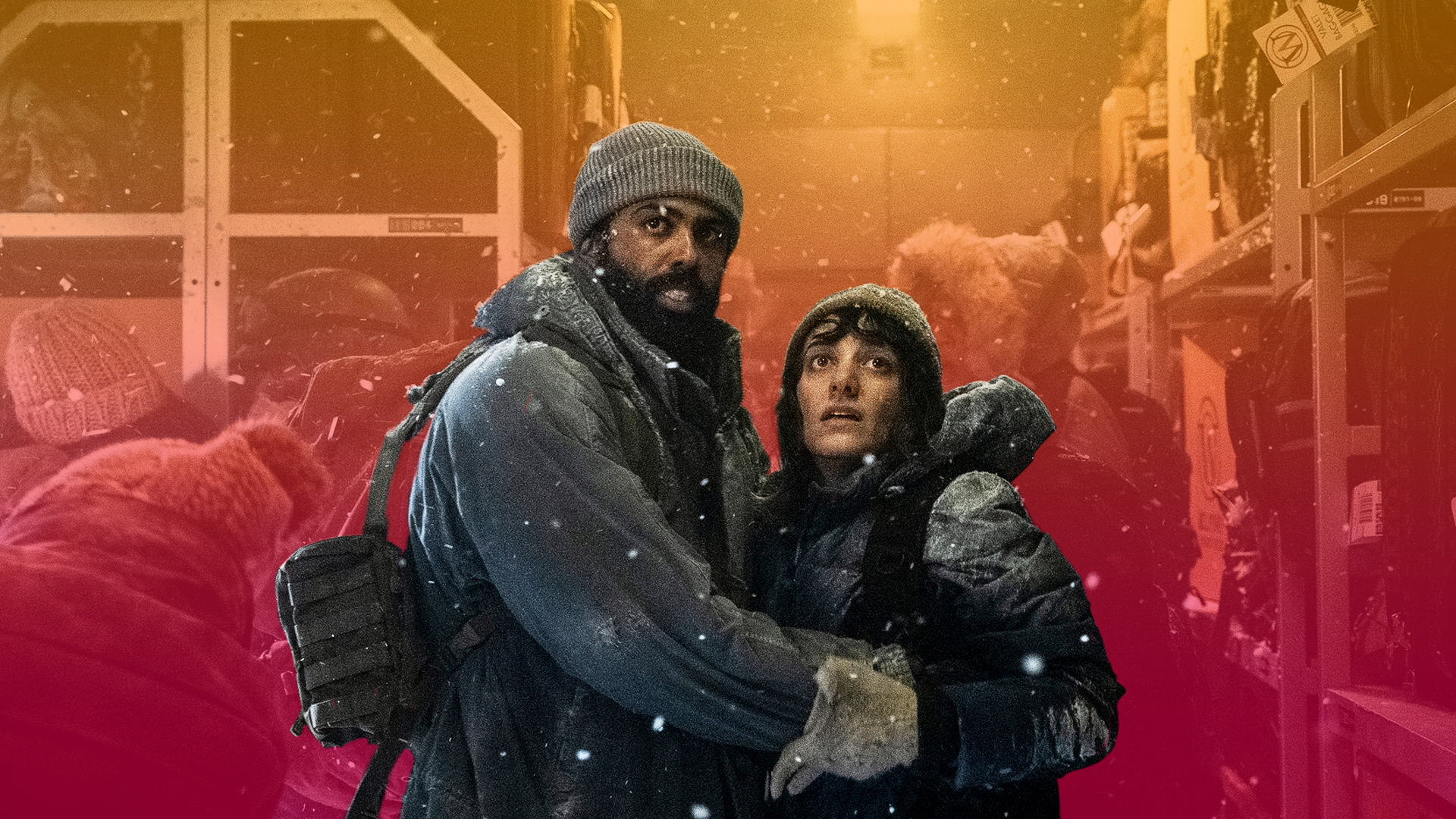 A man and woman dressed in bulky coats and heavy winter gear clutch each other and look fearfully offscreen as snow falls around them in TNT’s Snowpiercer series.