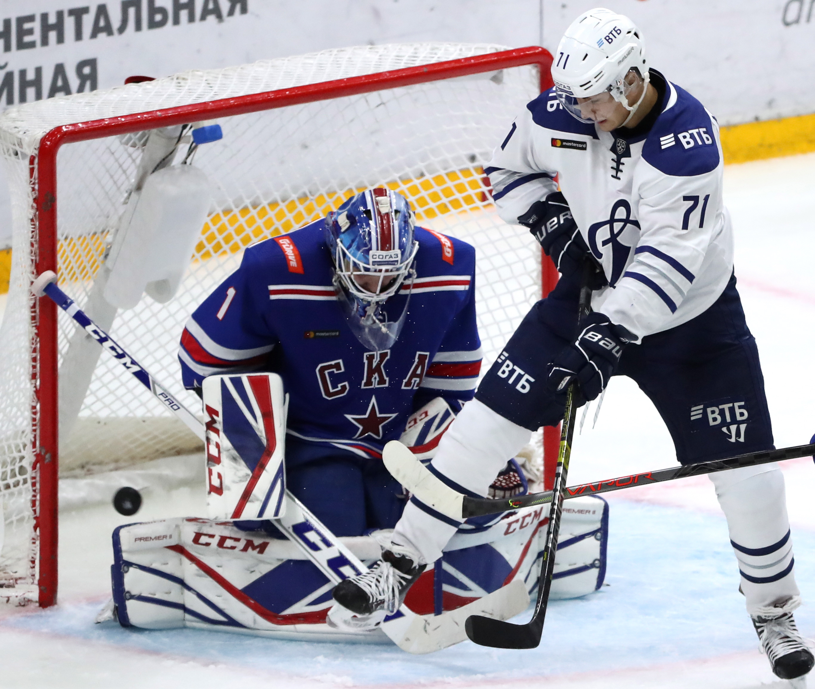 ST PETERSBURG, RUSSIA - SEPTEMBER 28, 2019: SKA St Petersburg's goaltender Alexei Melnichuk (L) and Dynamo Moscow's Ivan Muranov in a 2019/2020 KHL Regular Season ice hockey match between SKA St Petersburg and Dynamo Moscow at Ledovy Dvorets Arena (Ice Palace).