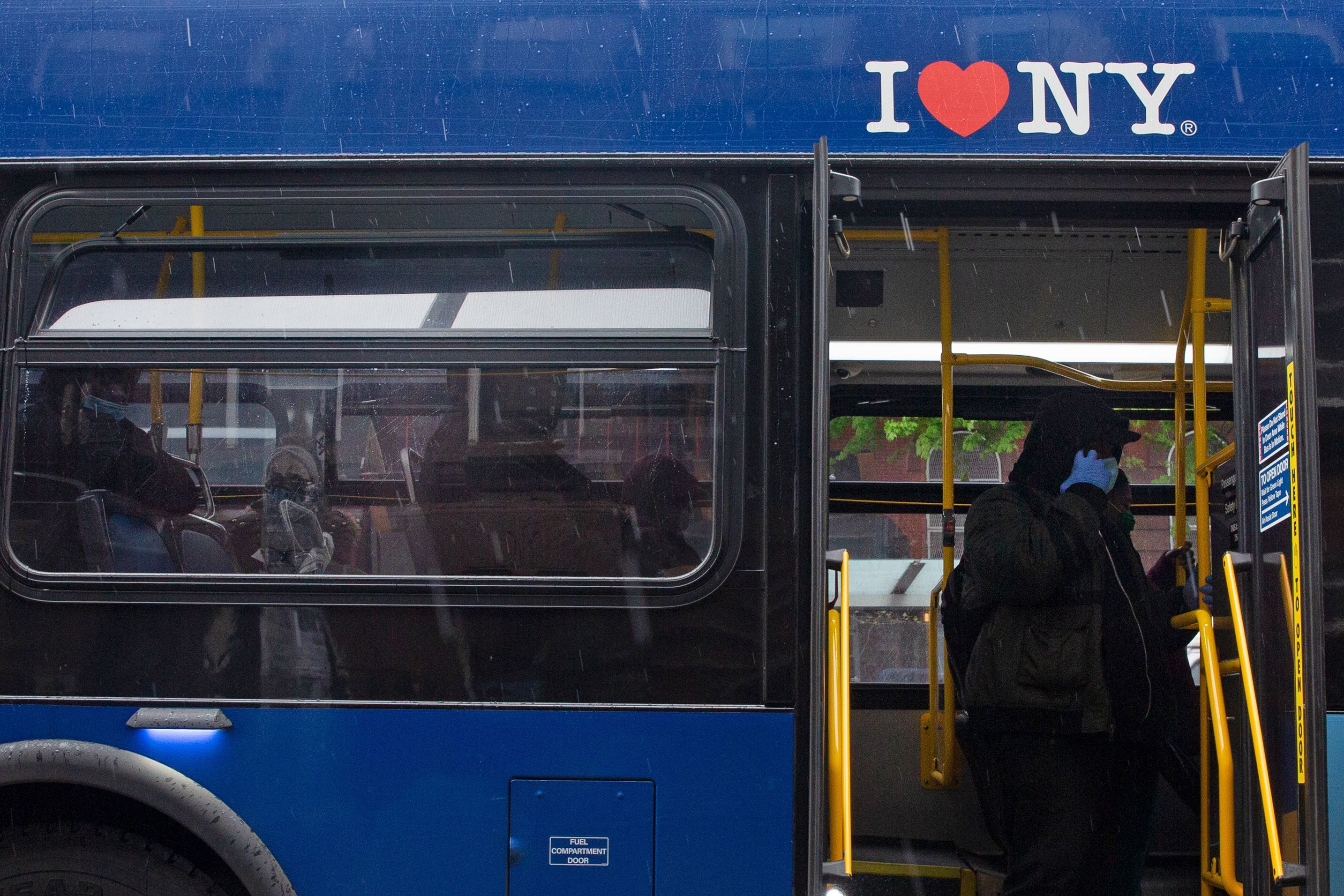 People ride an MTA bus through Brooklyn during the coronavirus outbreak.