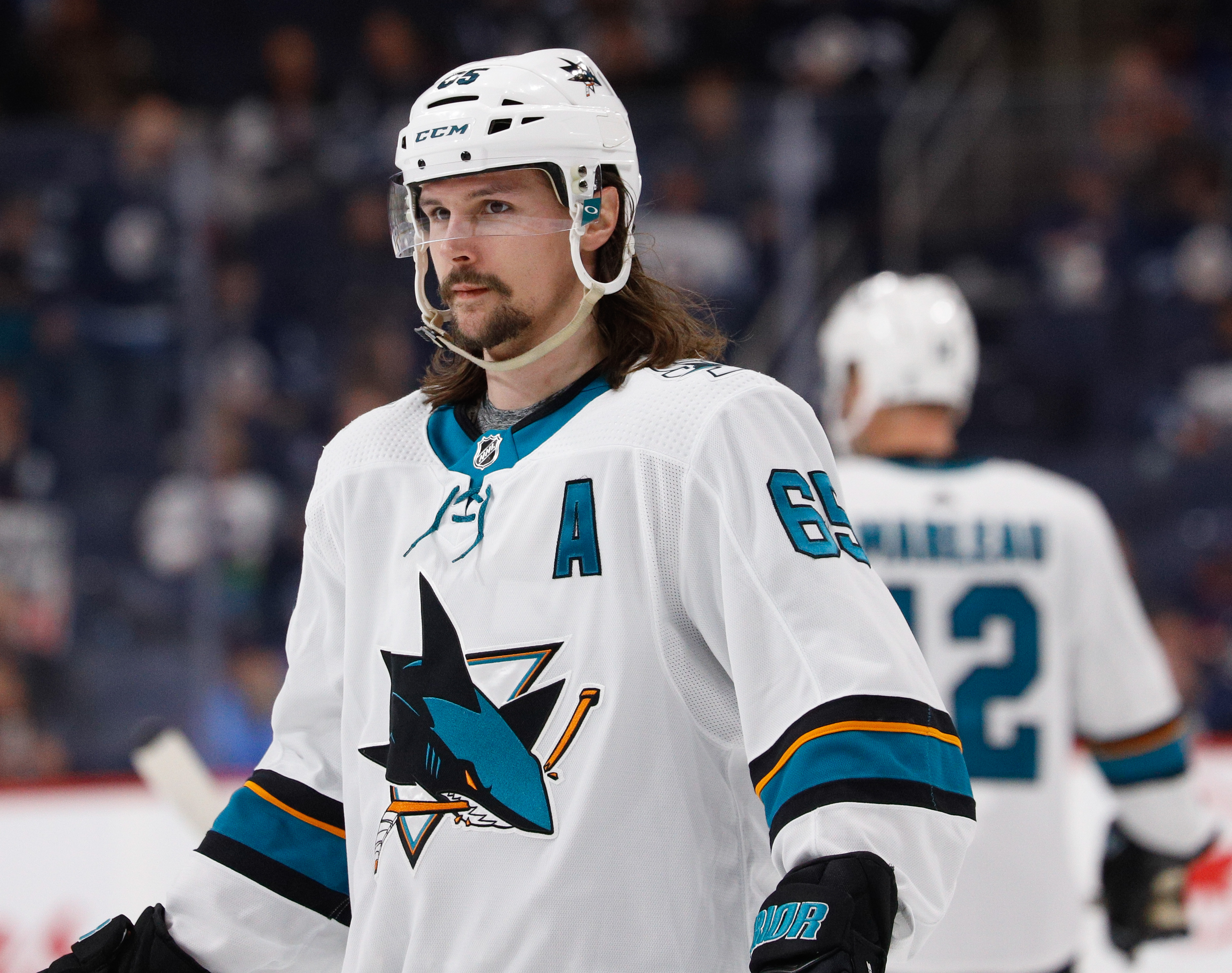 WINNIPEG, MB - FEBRUARY 14: Erik Karlsson #65 of the San Jose Sharks looks on during a first period stoppage in play against the Winnipeg Jets at the Bell MTS Place on February 14, 2020 in Winnipeg, Manitoba, Canada. The Sharks defeated the Jets 3-2.