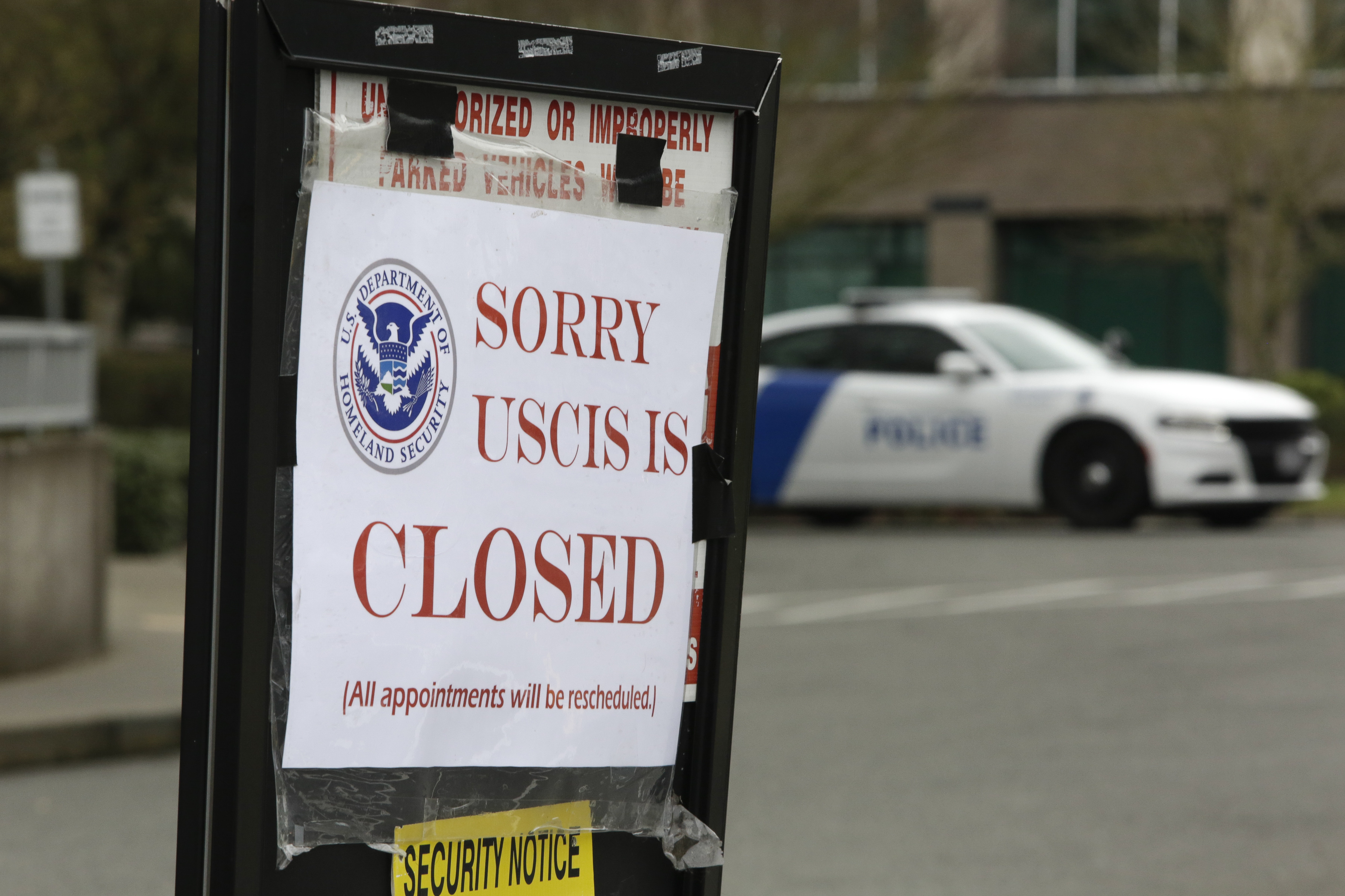 A sign indicates a USCIS office in Washington state is closed due to the coronavirus.