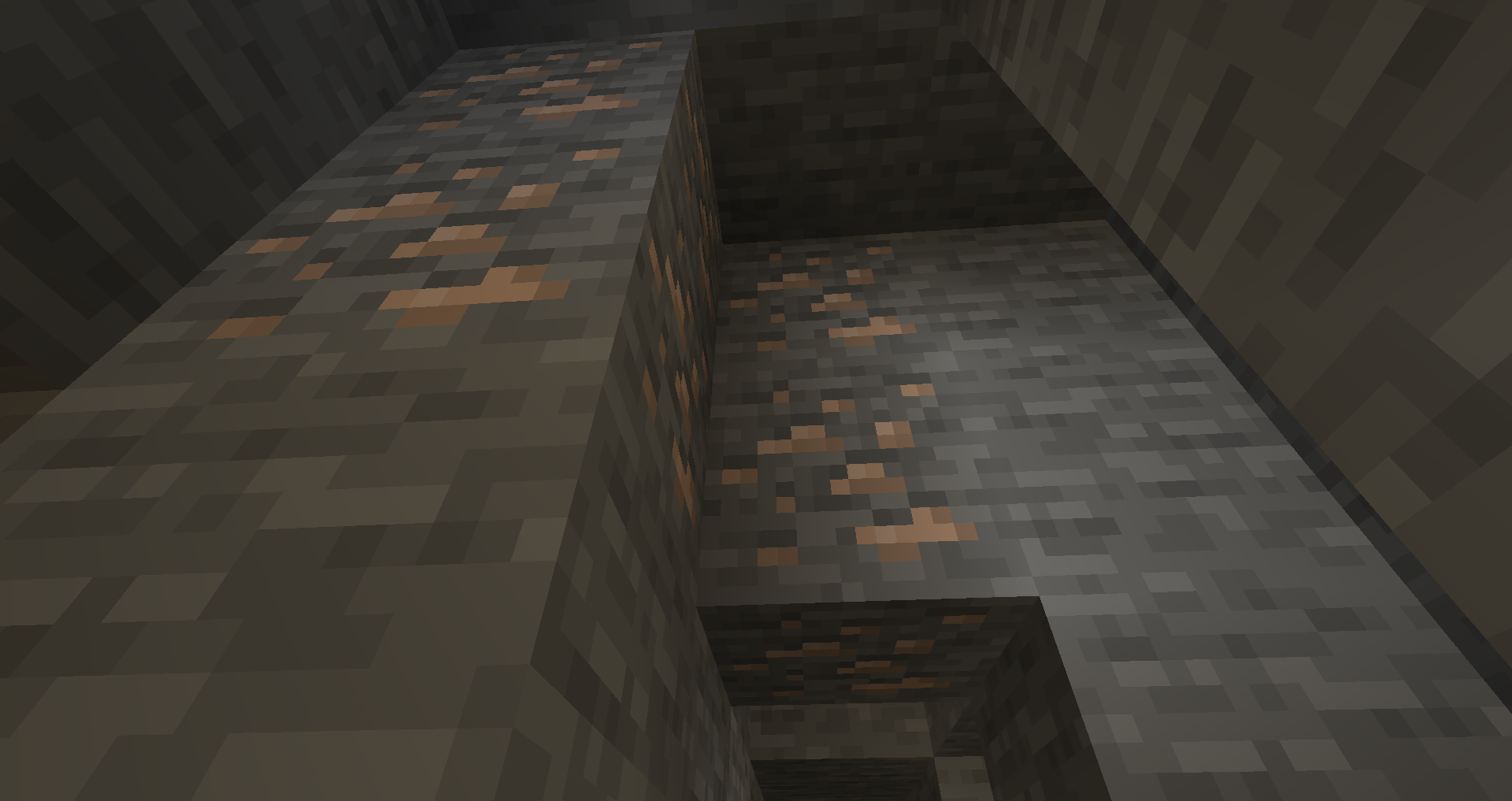 A wall of Cobblestone in Minecraft with some Iron Ore blocks speckled in