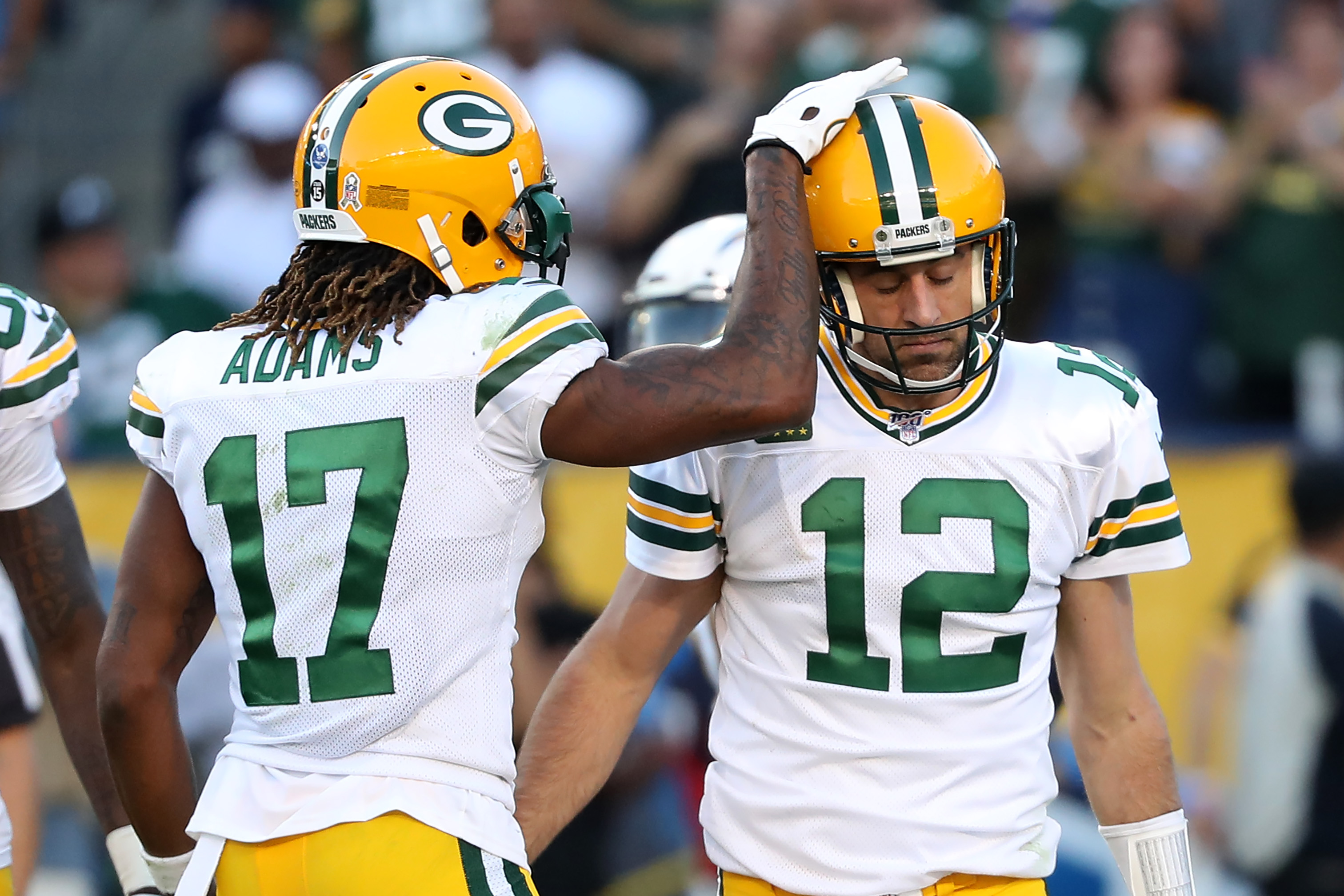 Davante Adams congratulates Aaron Rodgers of the Green Bay Packers after scoring a two-point conversion during the second half of a game against the Los Angeles Chargers at Dignity Health Sports Park on November 03, 2019 in Carson, California.