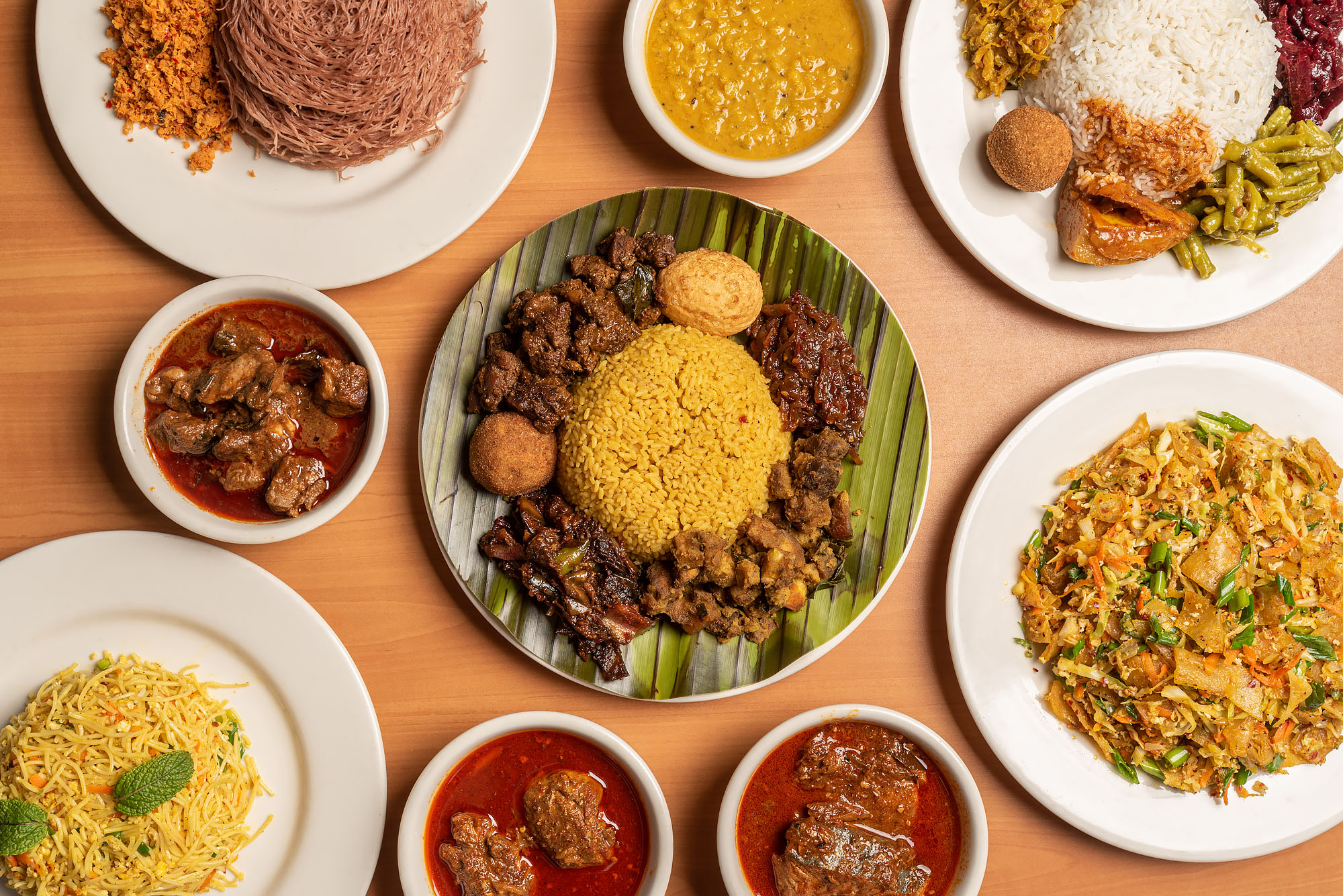 Several Sri Lankan dishes placed on a brown table.
