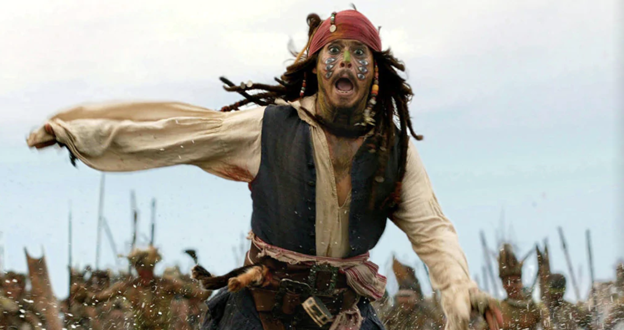 Johnny Depp as Captain Jack Sparrow in a “Pirates of the Caribbean” movie running toward the camera and yelling.