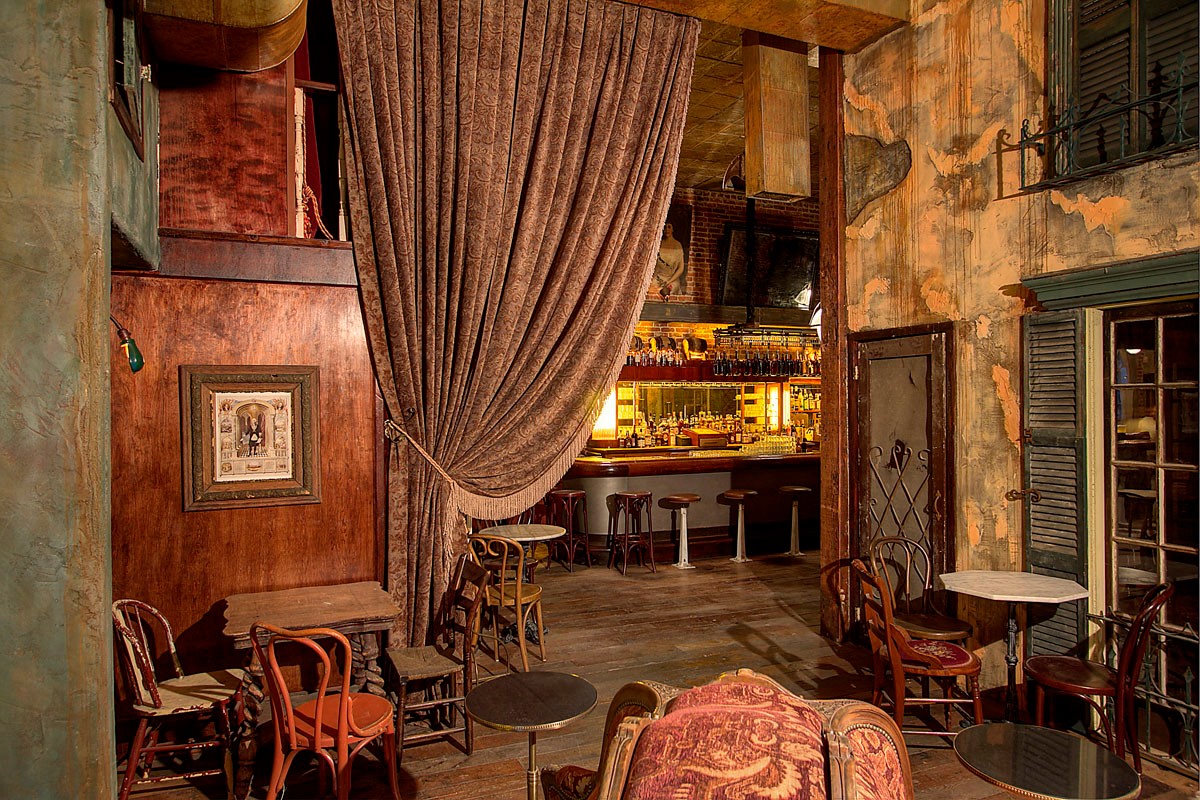 A Southern-themed bar in Hollywood complete with drapes and wooden chairs and a fireplace.