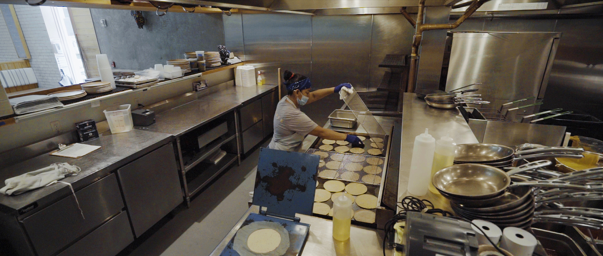 A Suerte staffer making tortillas in the kitchen