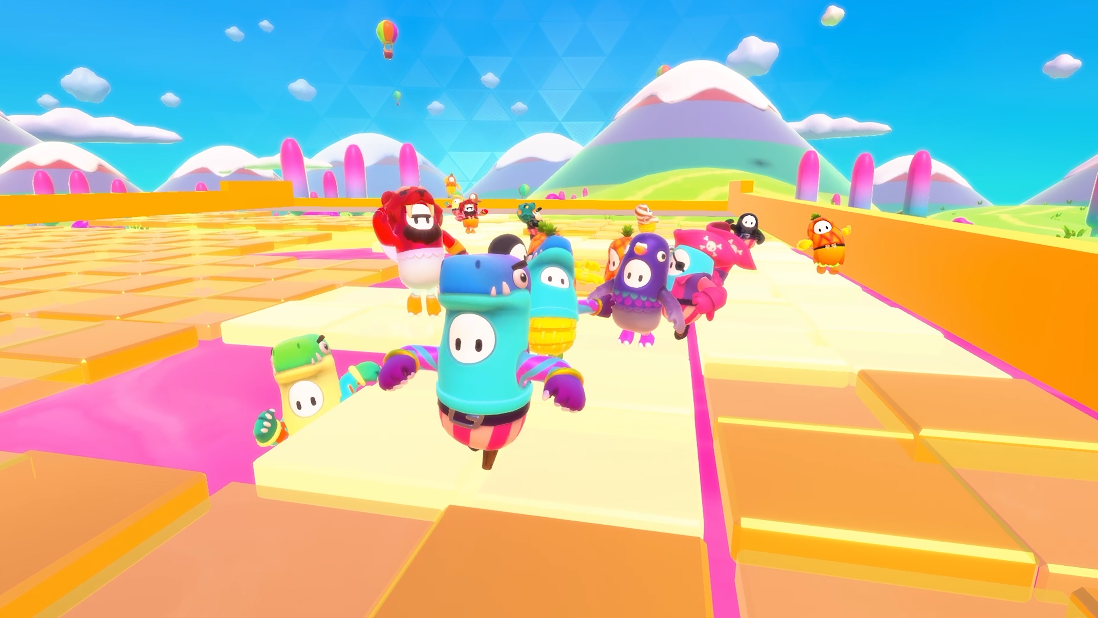 A bunch of beans race in colorful costumes in a screenshot from Fall Guys: Ultimate Knockout