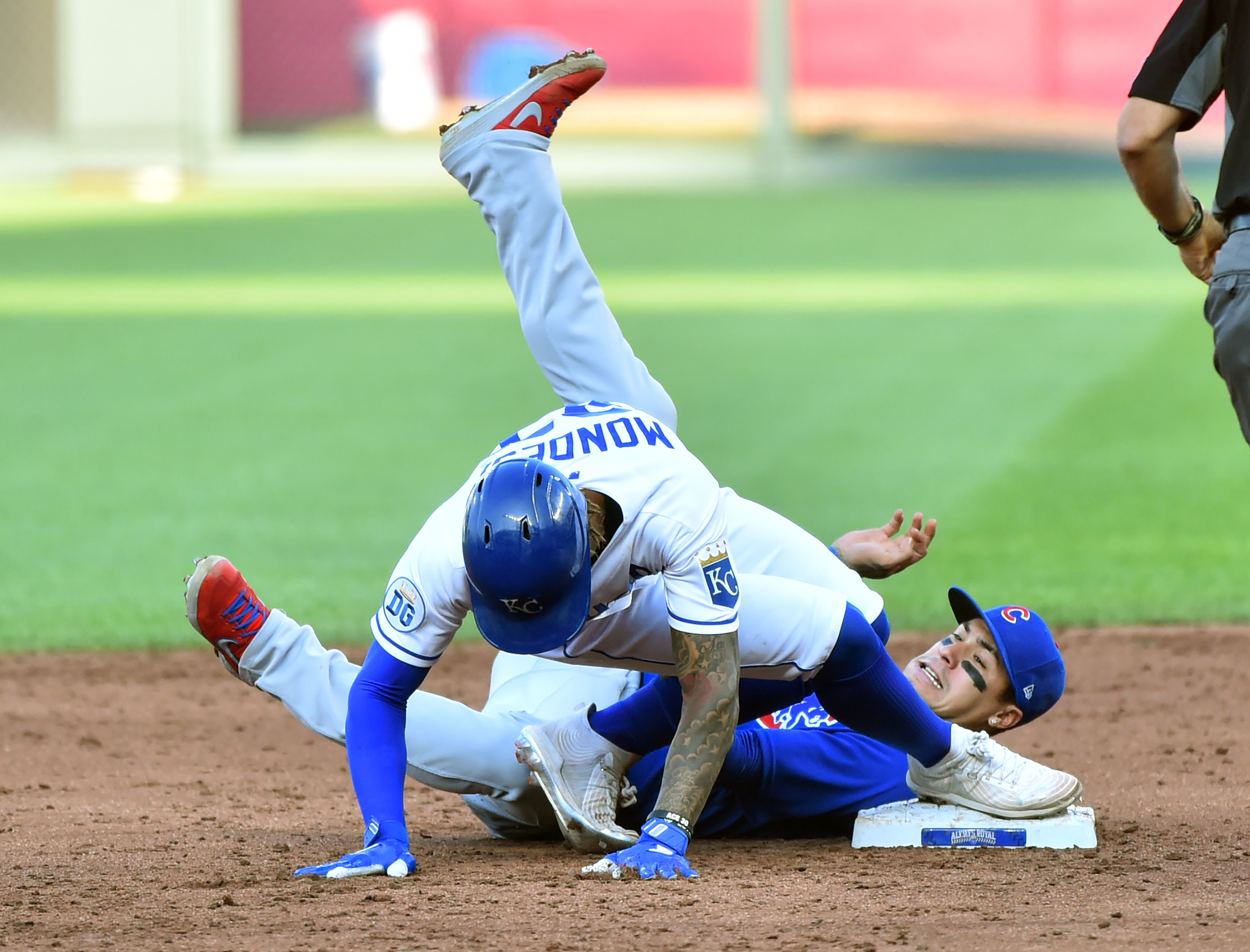 Adalberto Mondesi #27 of the Kansas City Royals slides into second for a double past the tage of Javier Baez #9 of the Chicago Cubs in the third inning at Kauffman Stadium on August 06, 2020 in Kansas City, Missouri.