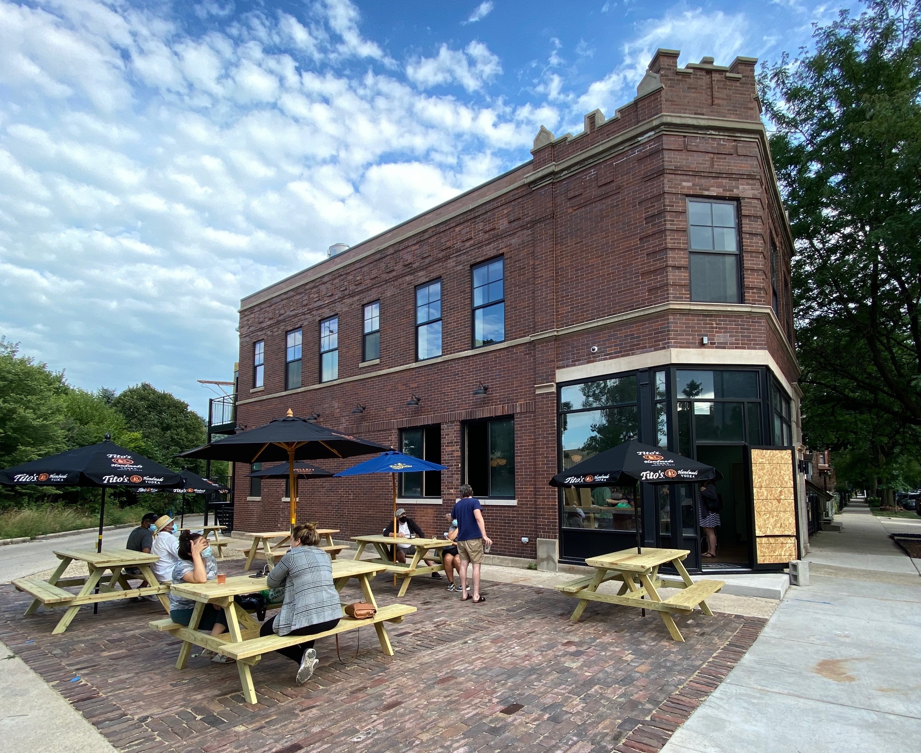 A large brick building with picnic tables