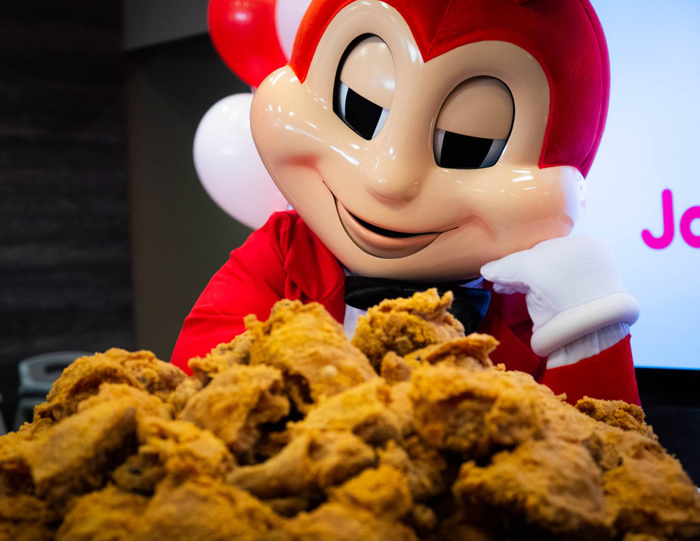 The Jollibee mascot and and a bucket of its “chickenjoy” fried chicken pieces.