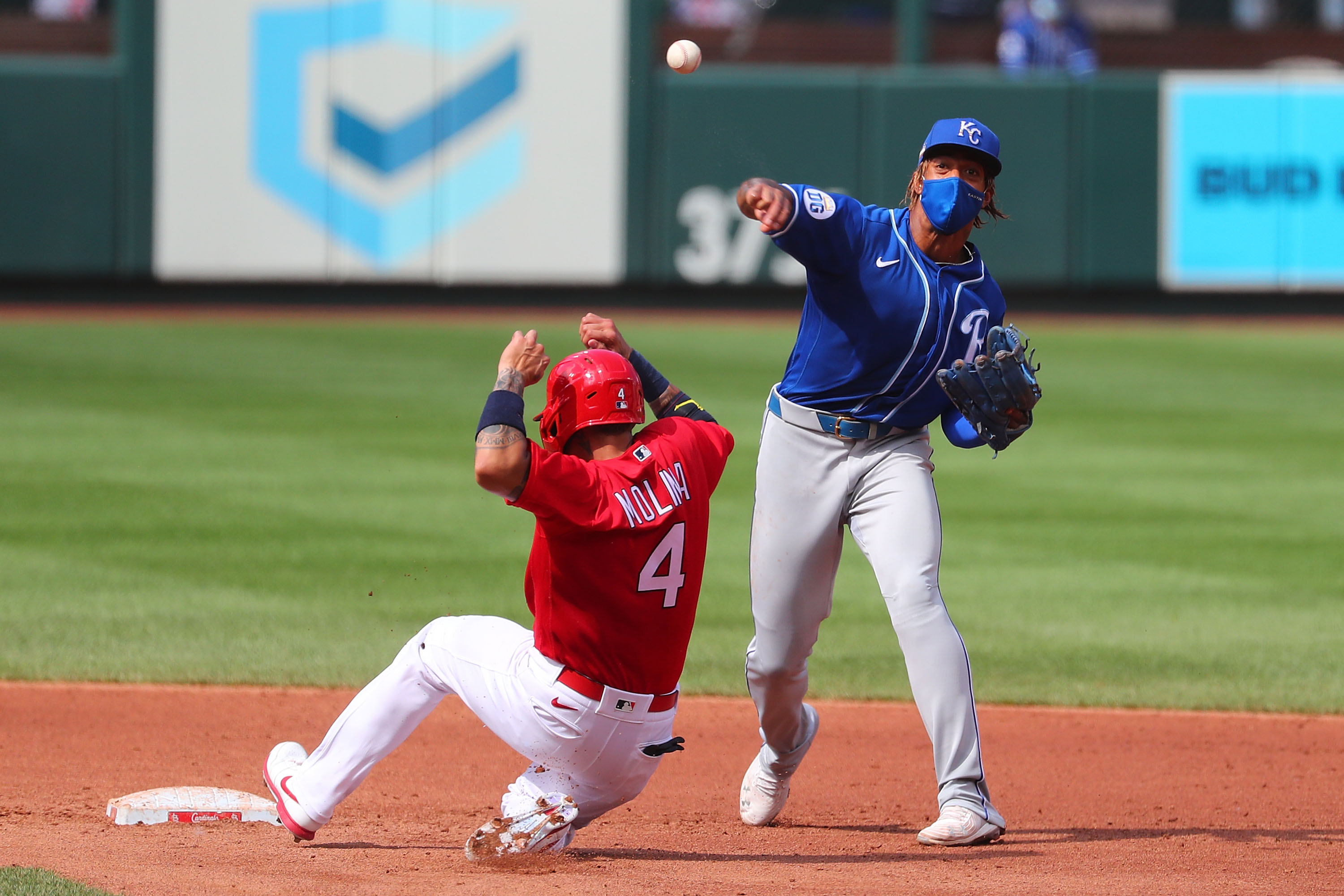 Adalberto Mondesi #27 of the Kansas City Royals turns a double play over Yadier Molina #4 of the St. Louis Cardinals in the fourth inning at Busch Stadium on July 22, 2020 in St Louis, Missouri.