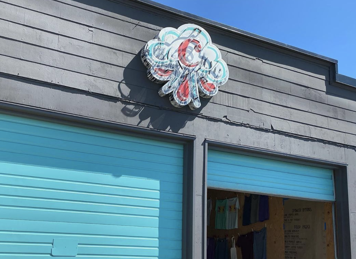 The Cloudburst Brewing logo on top of its new Ballard taproom, with a light-blue painted garage door below
