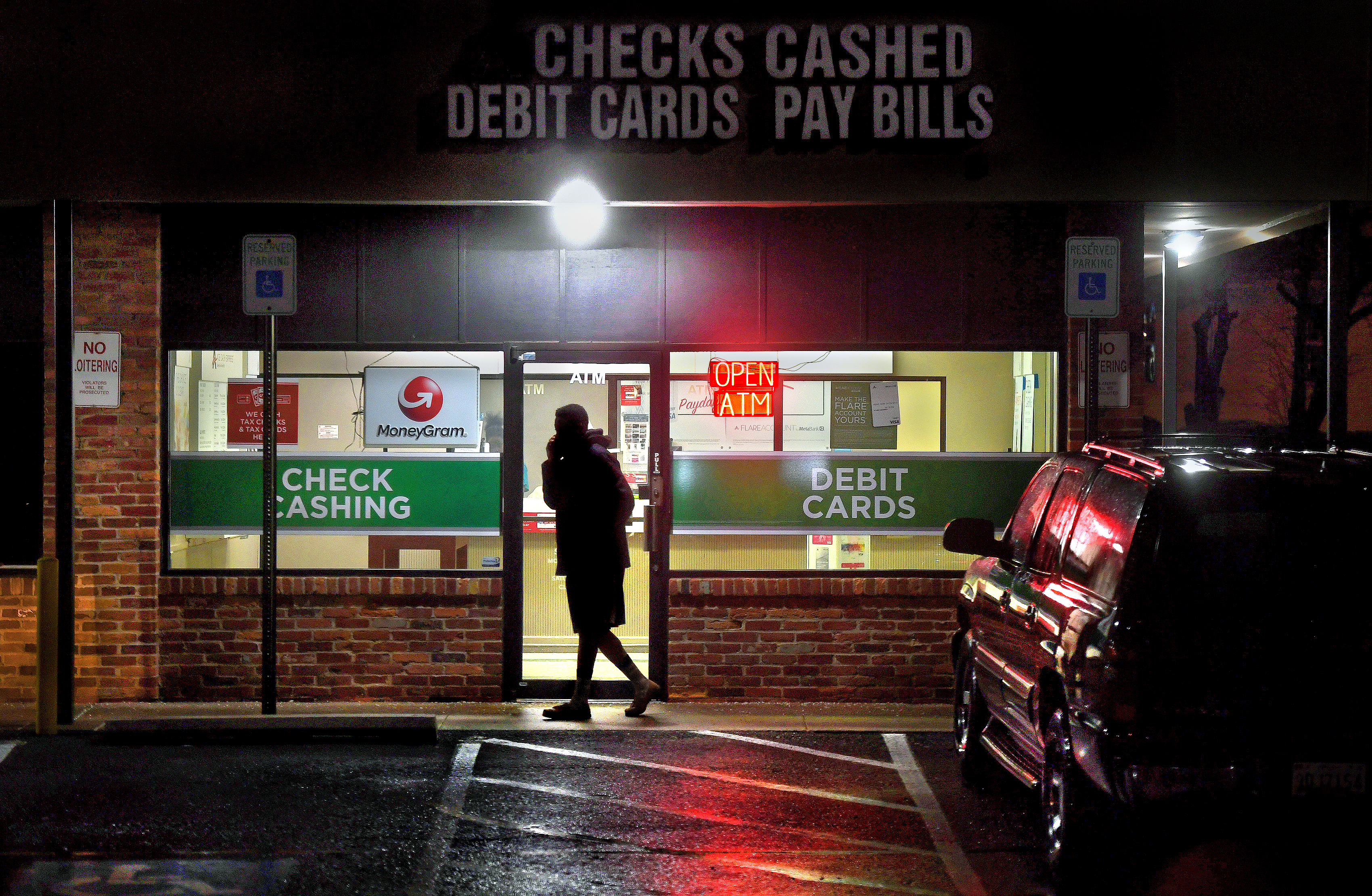 A person leaving a payday loan store.