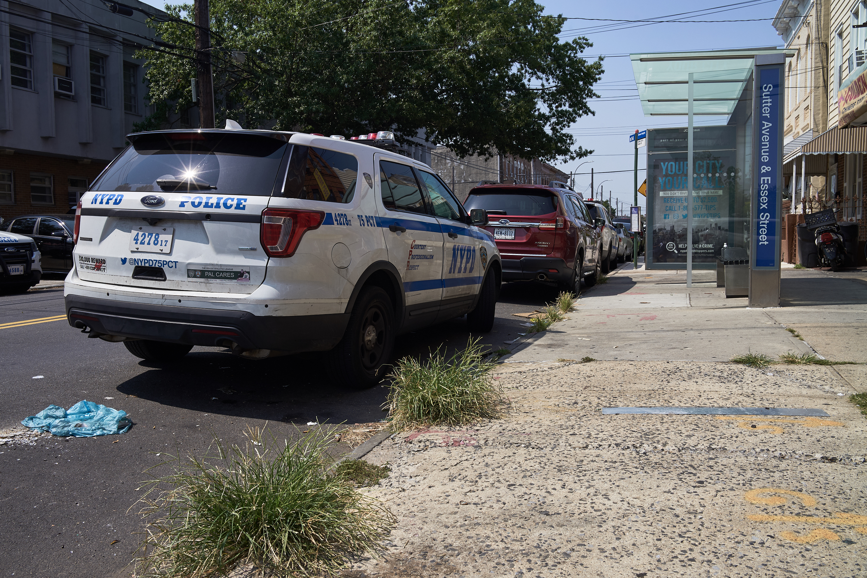 A NYPD vehicle parks at a B14 bus stop across the street from the 75th precinct in East New York on Aug. 25, 2020.