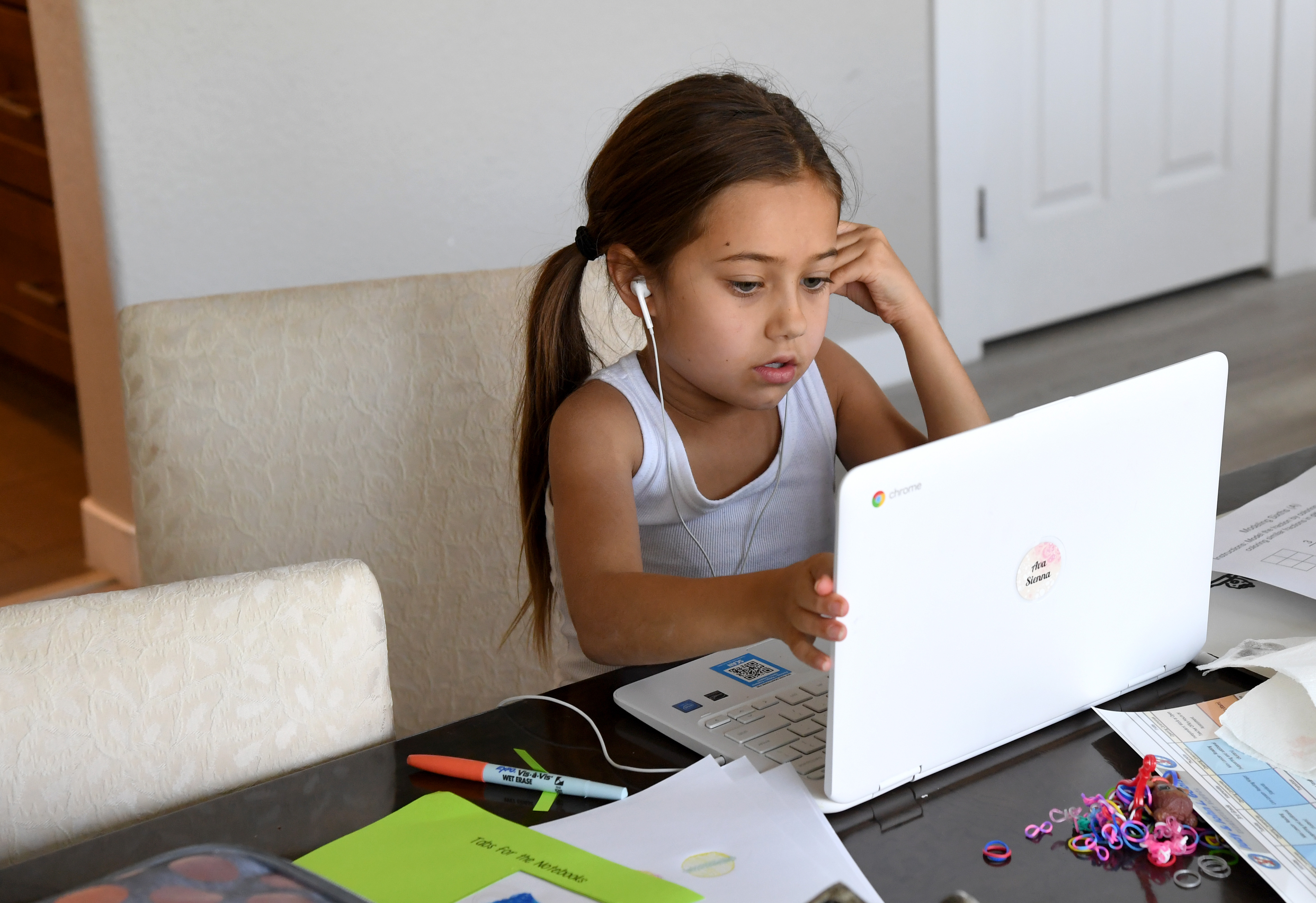 A nine-year-old girl takes an online class at a friend’s home during the first week of distance learning for Nevada’s Clark County School District.