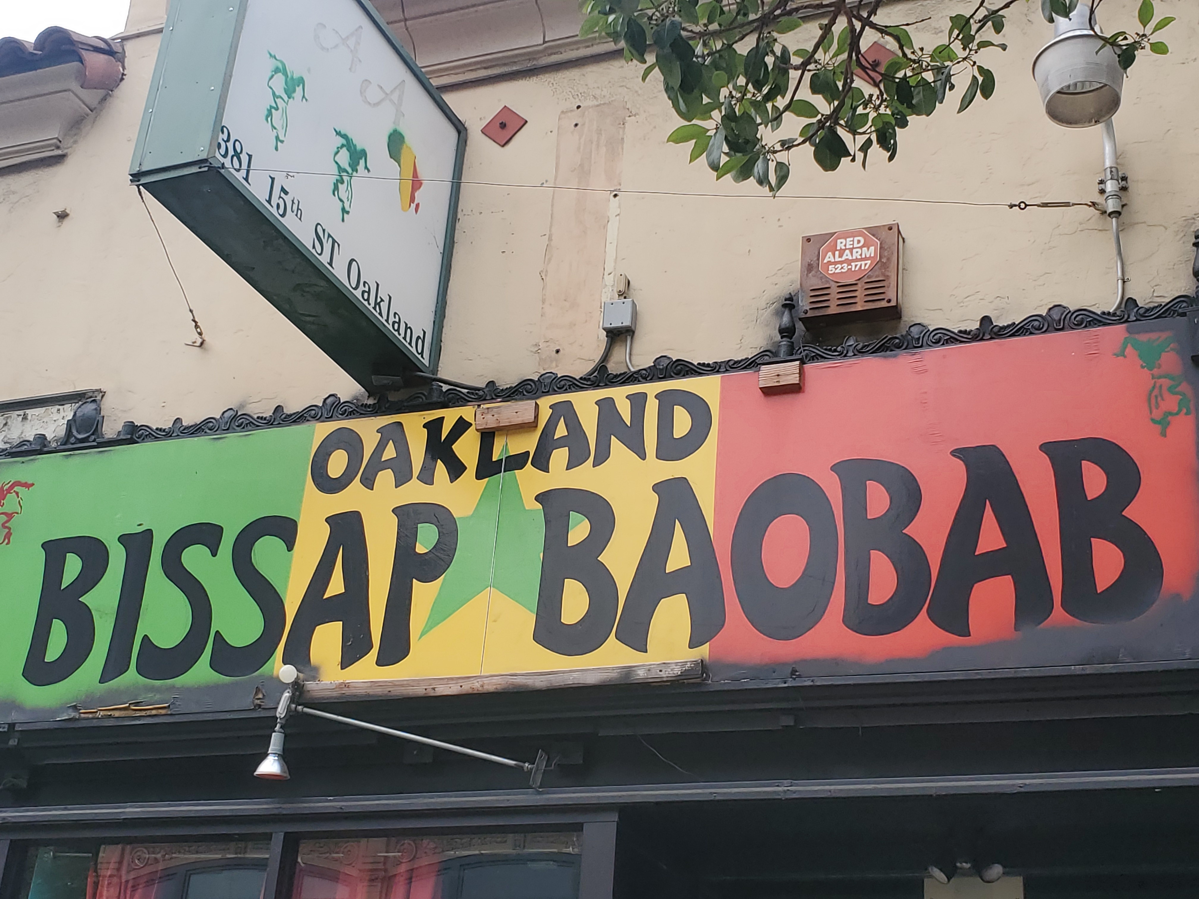 The exterior sign of Baobab Oakland, in green, yellow, and red