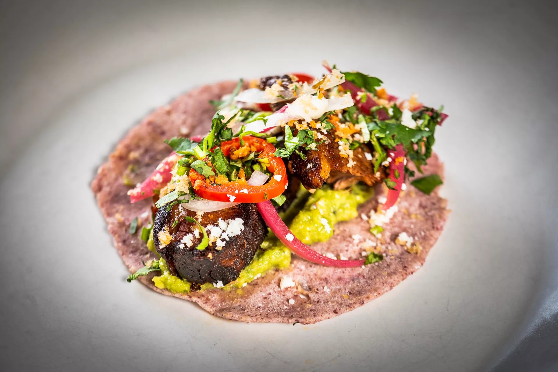 A brisket barbacoa taco from Poca Madre made with rare red corn from Oaxaca.