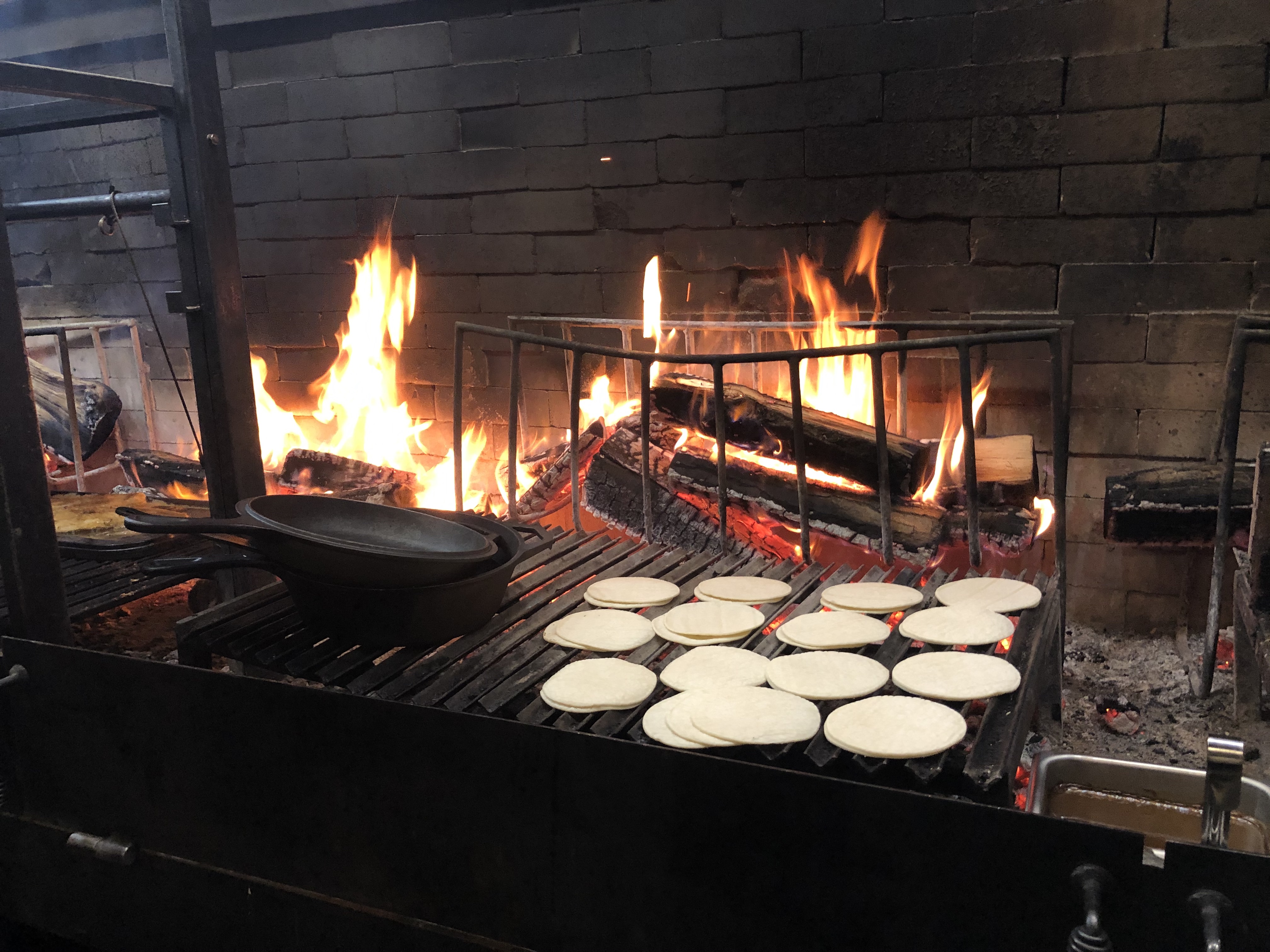 Flower tortillas on a grill grate over fire