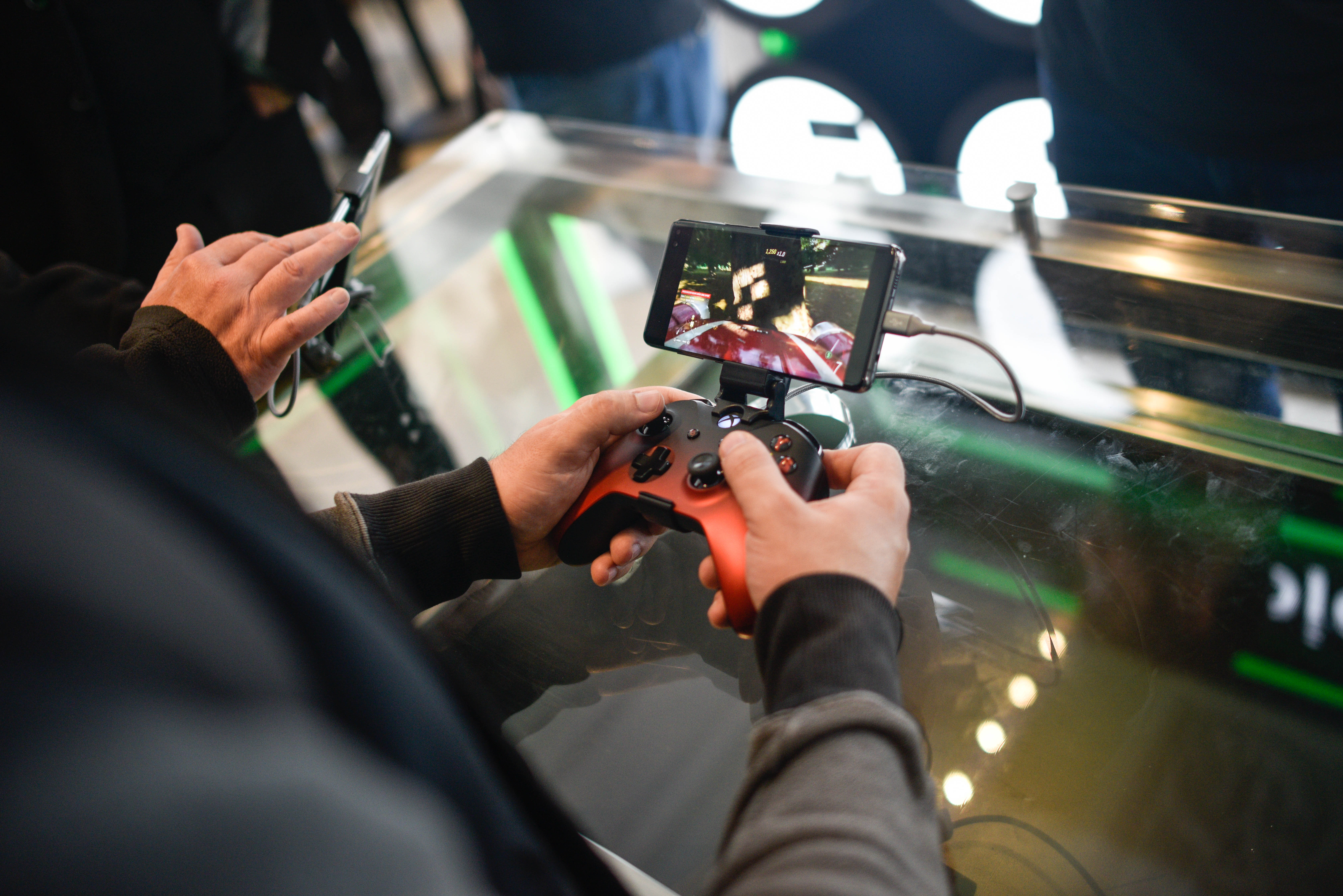 a customer plays Xbox One games on a mobile device at the xCloud display in the London Microsoft Store.