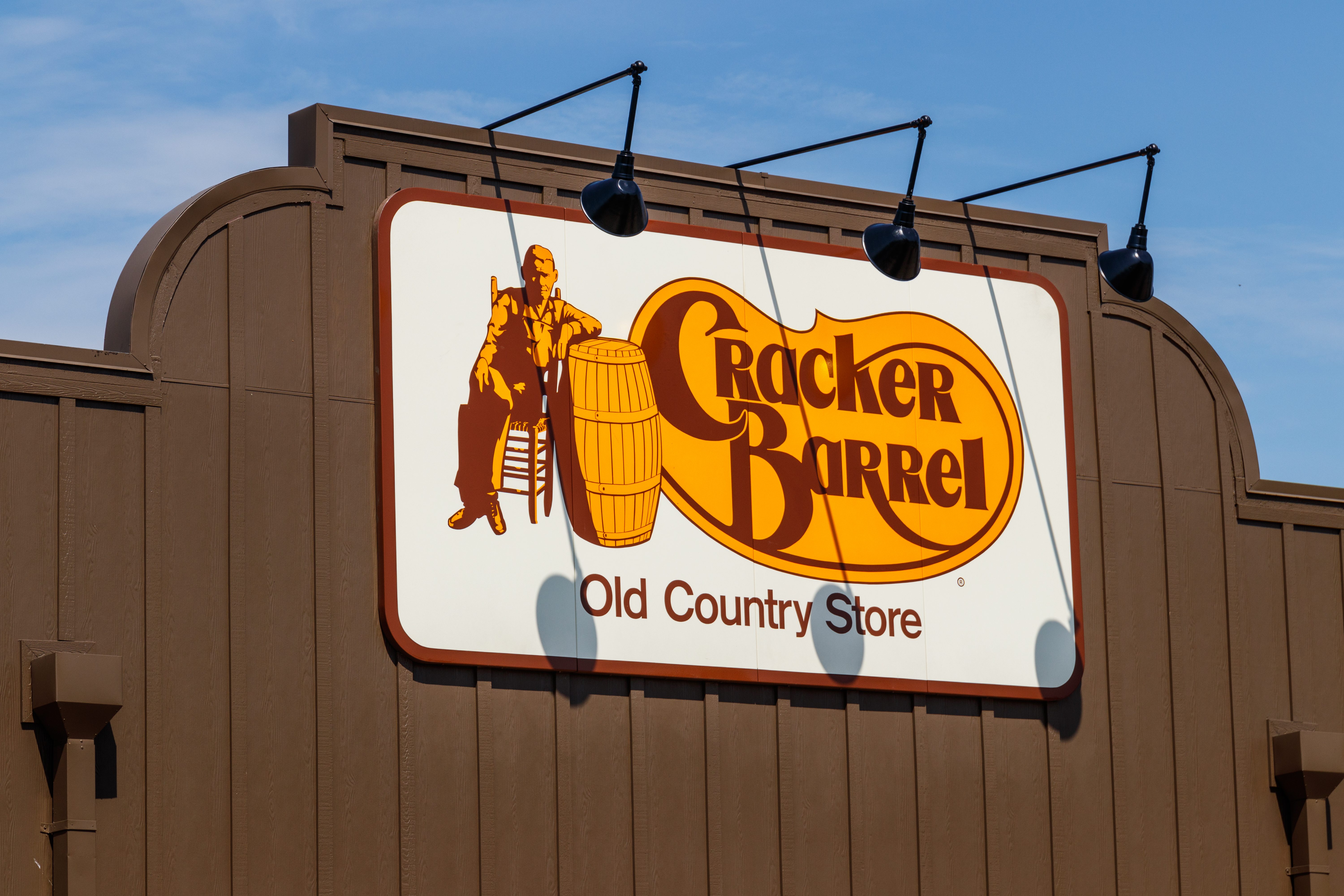 Cracker Barrel restaurant sign against a blue sky.