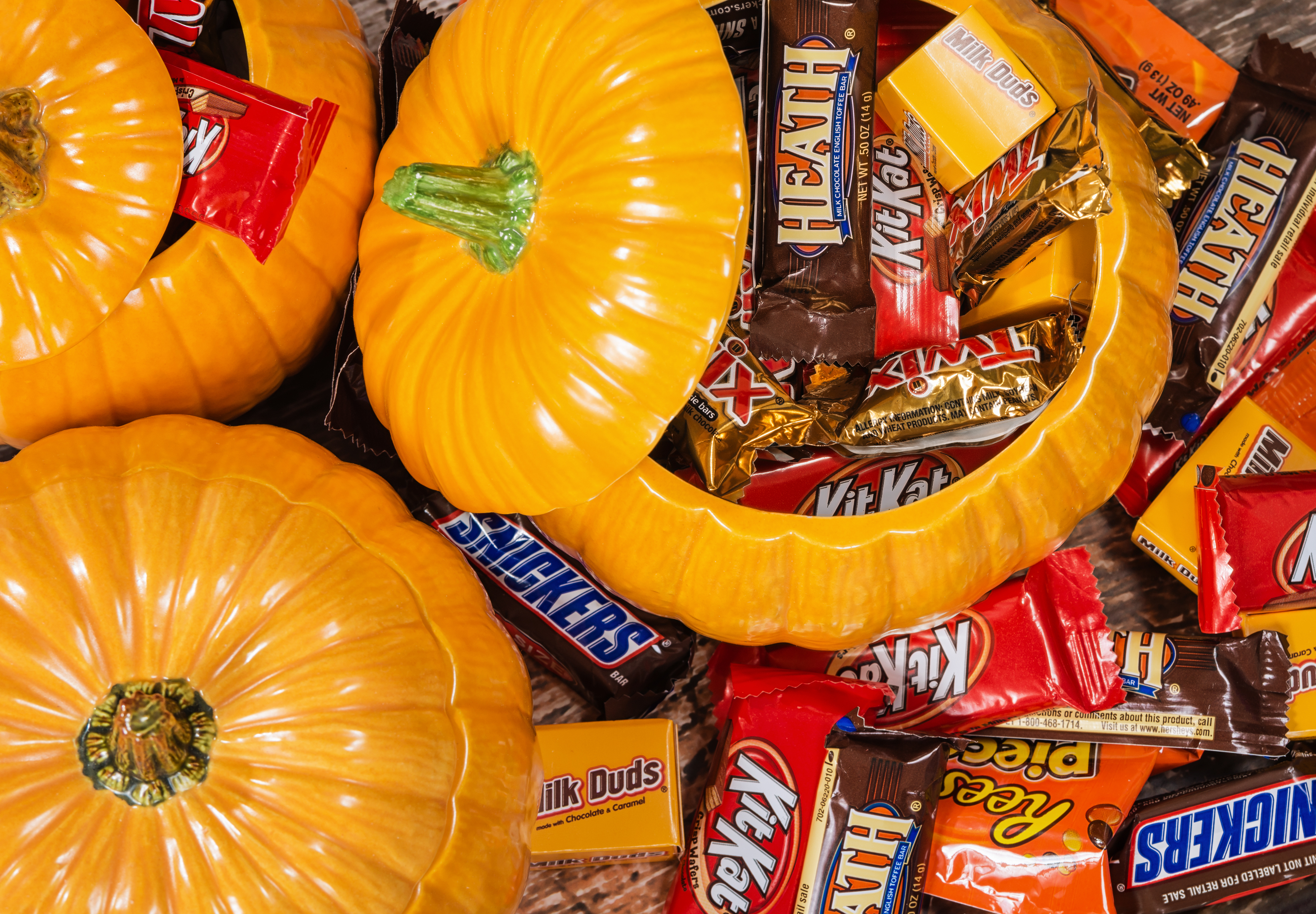 Decorative pumpkins filled with assorted Halloween chocolate candy made by Mars, Incorporated and the Hershey Company. 