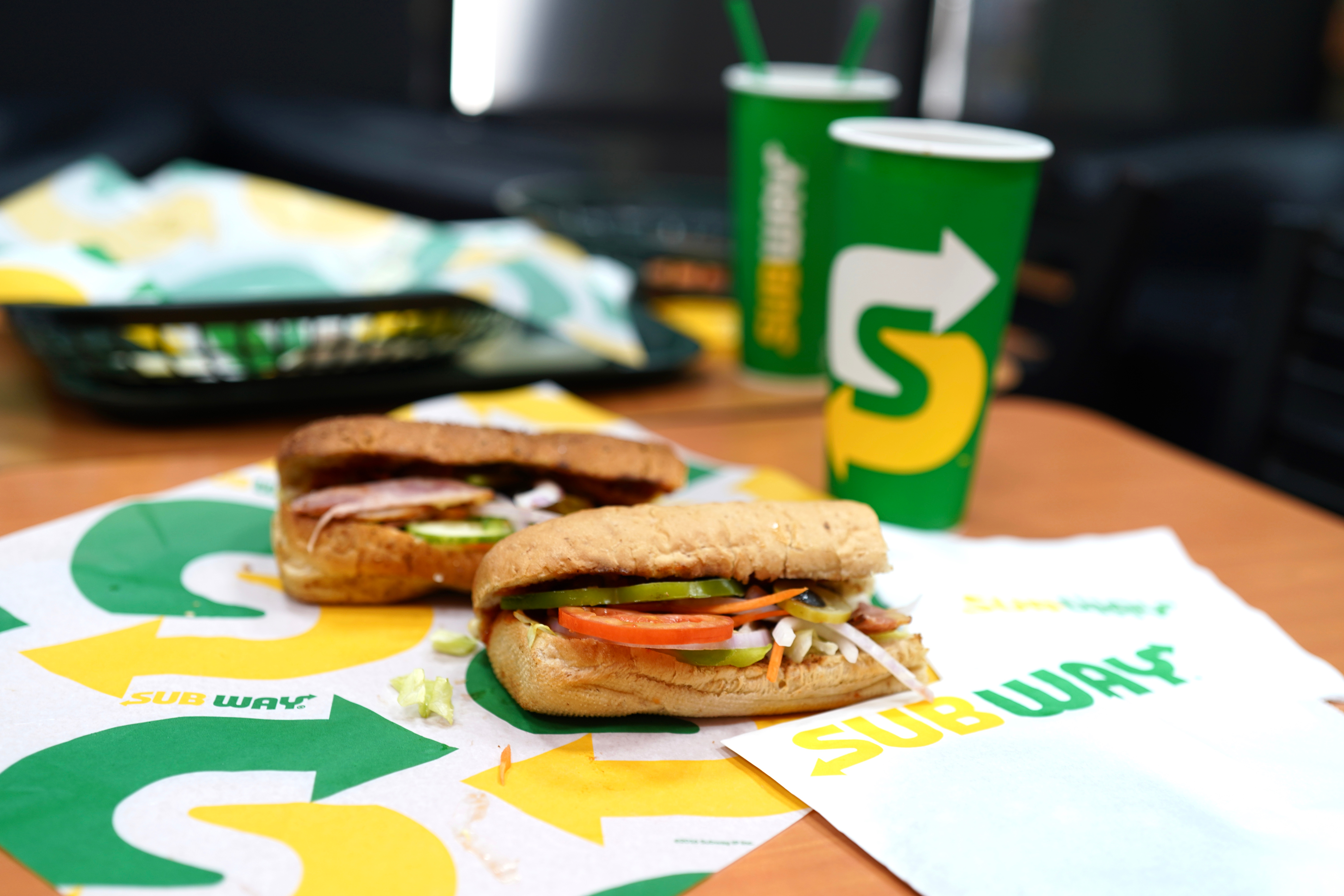 Two sandwiches on Subway branded paper