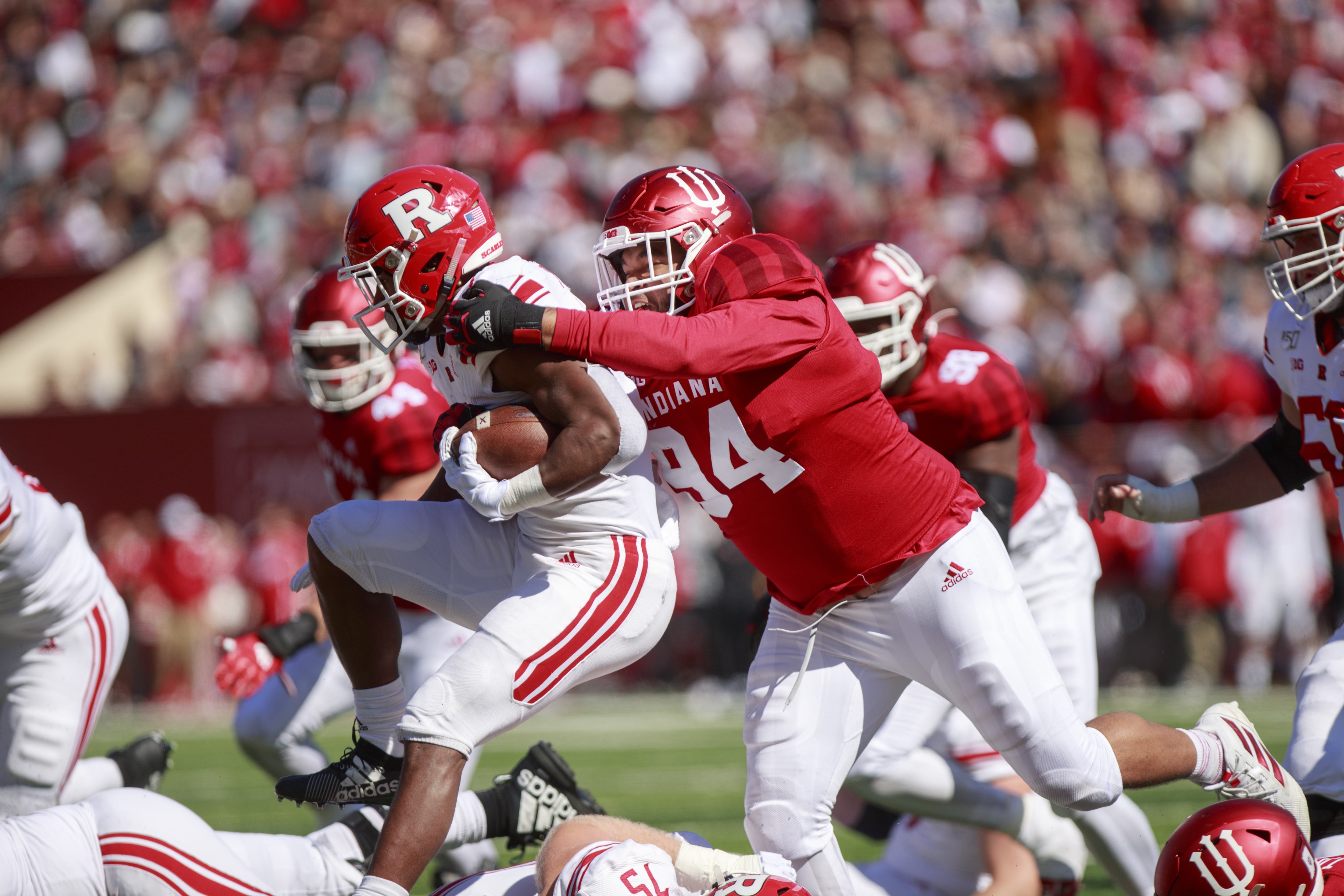 Rutgers’ Isaih Pacheco (1) is tackled by Indiana University’...