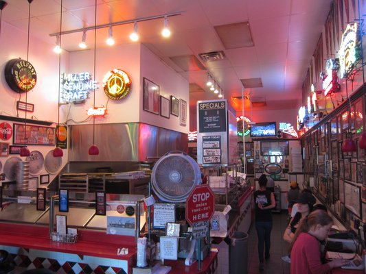 The colorful neon interior of an old school pizza place in Los Angeles, CA.