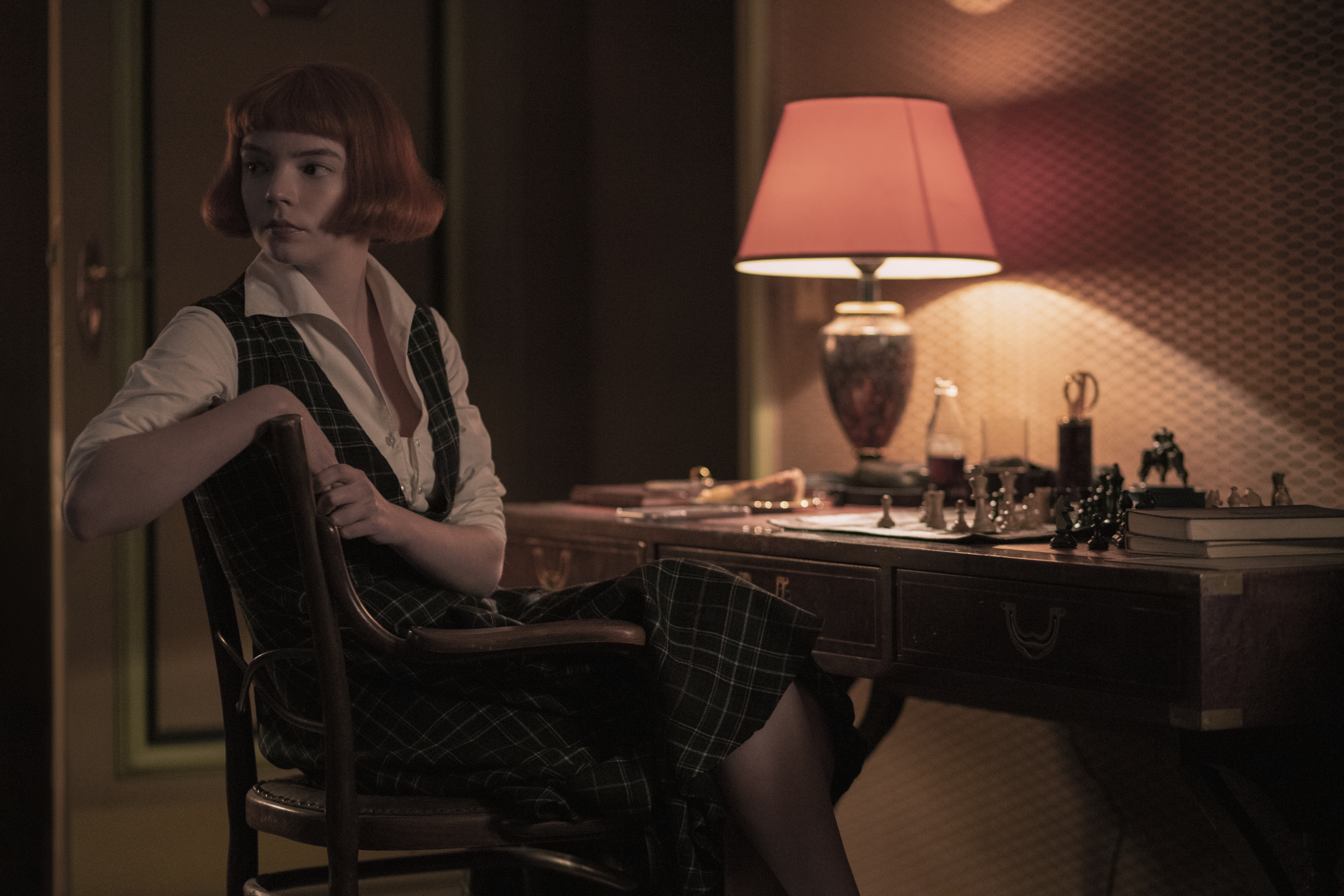 Beth, played by Anya Taylor-Joy, studies a chessboard before a tournament.