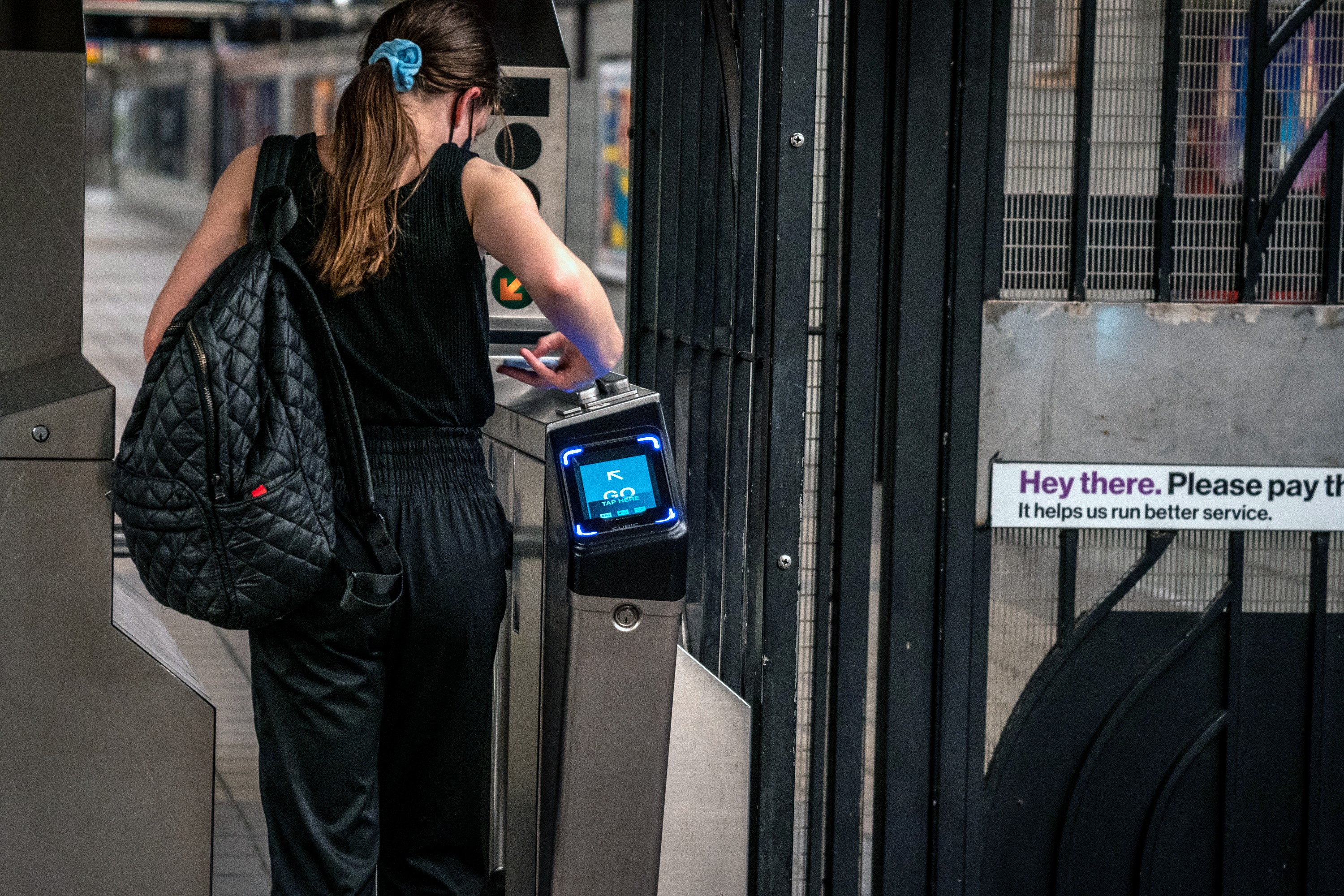 A commuter taps her phone on an OMNY pad at TimesSq-42 Street, Oct. 24, 2020.