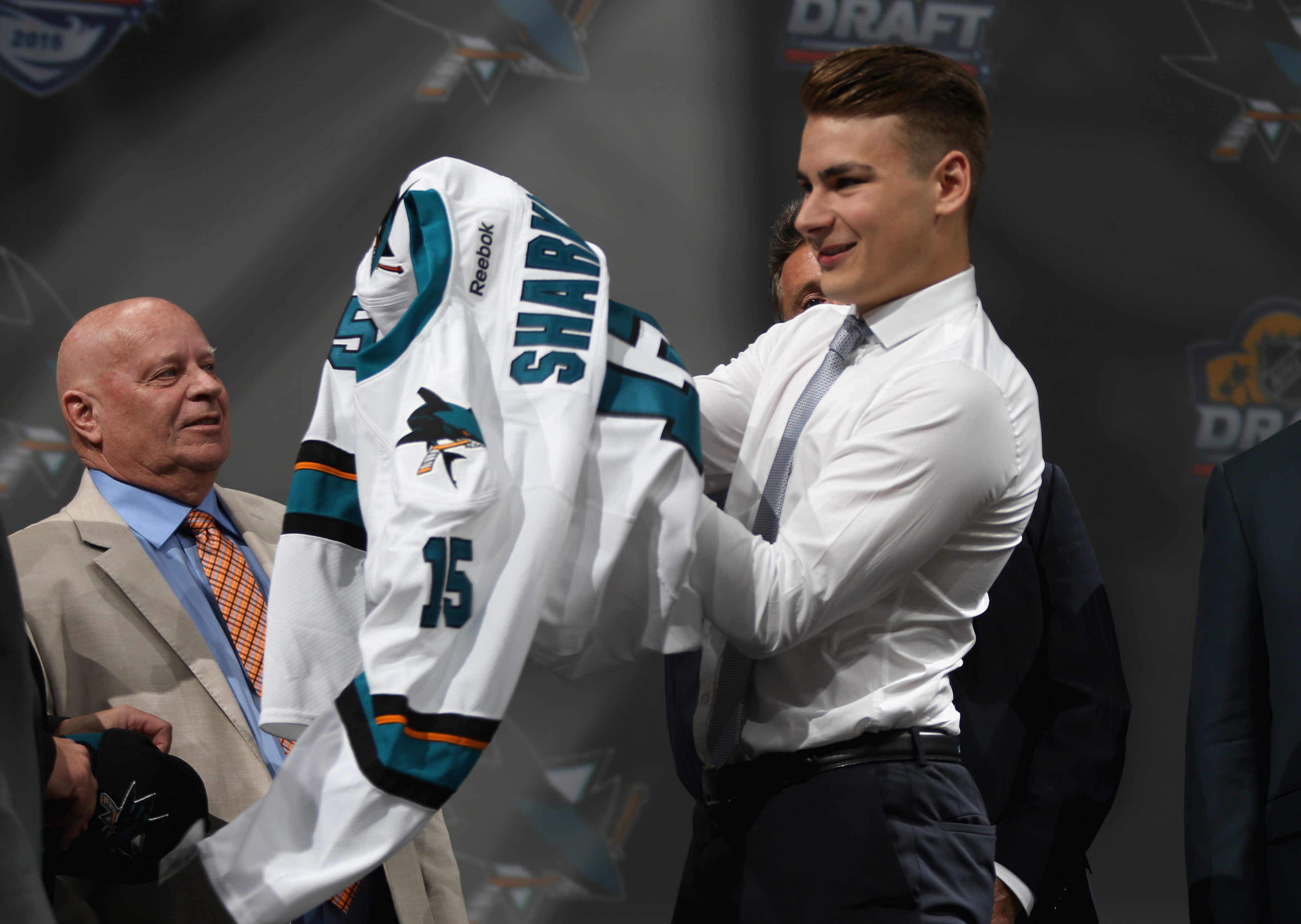 Timo Meier puts on his jersey after being selected ninth overall by the San Jose Sharks during Round One of the 2015 NHL Draft at BB&amp;T Center on June 26, 2015 in Sunrise, Florida.