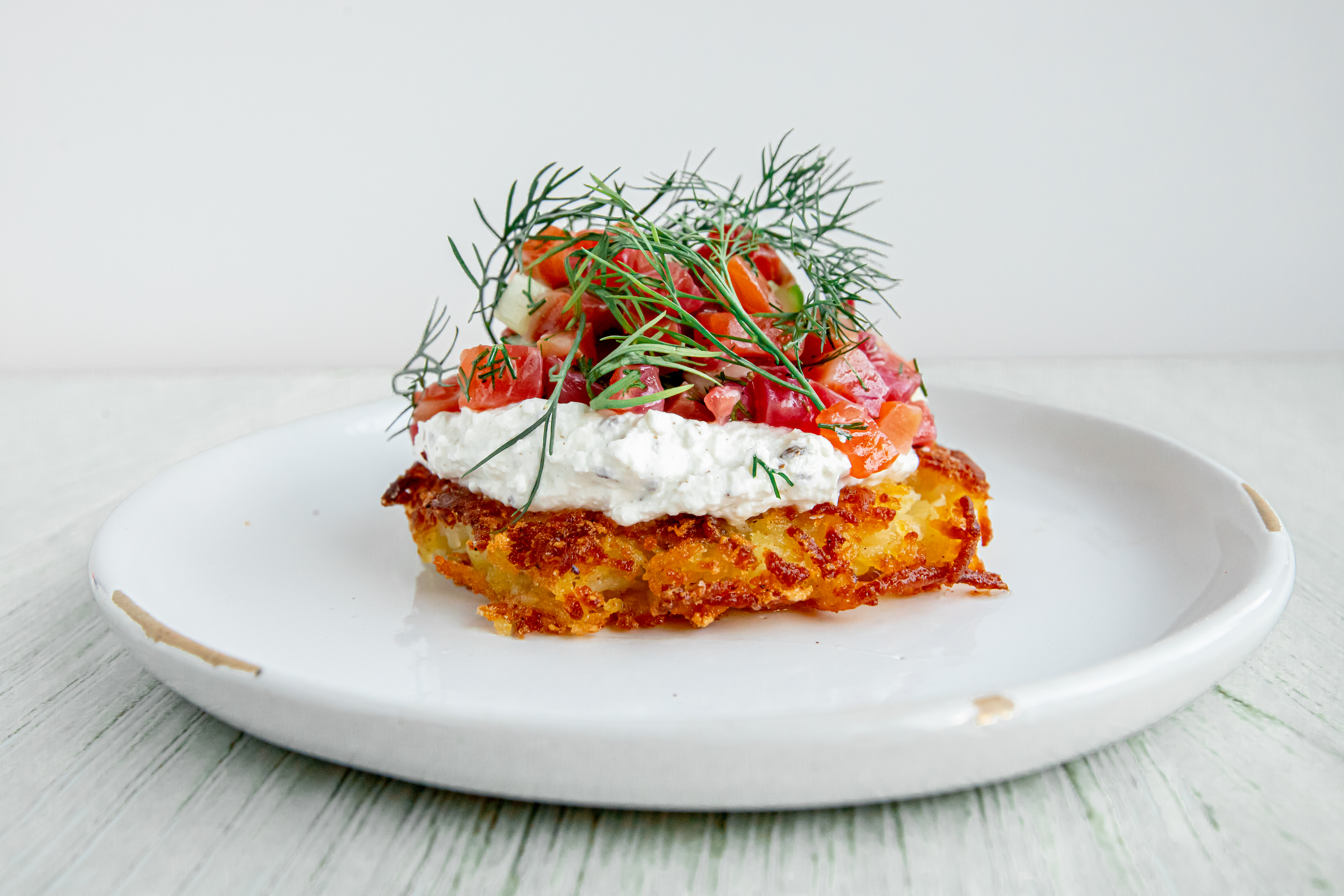 A cured arctic char rosti approximates lox and schmear with the addition of cucumber, a lemon dill vinaigrette, and a caraway quark that Anderson compares to a German ricotta.
