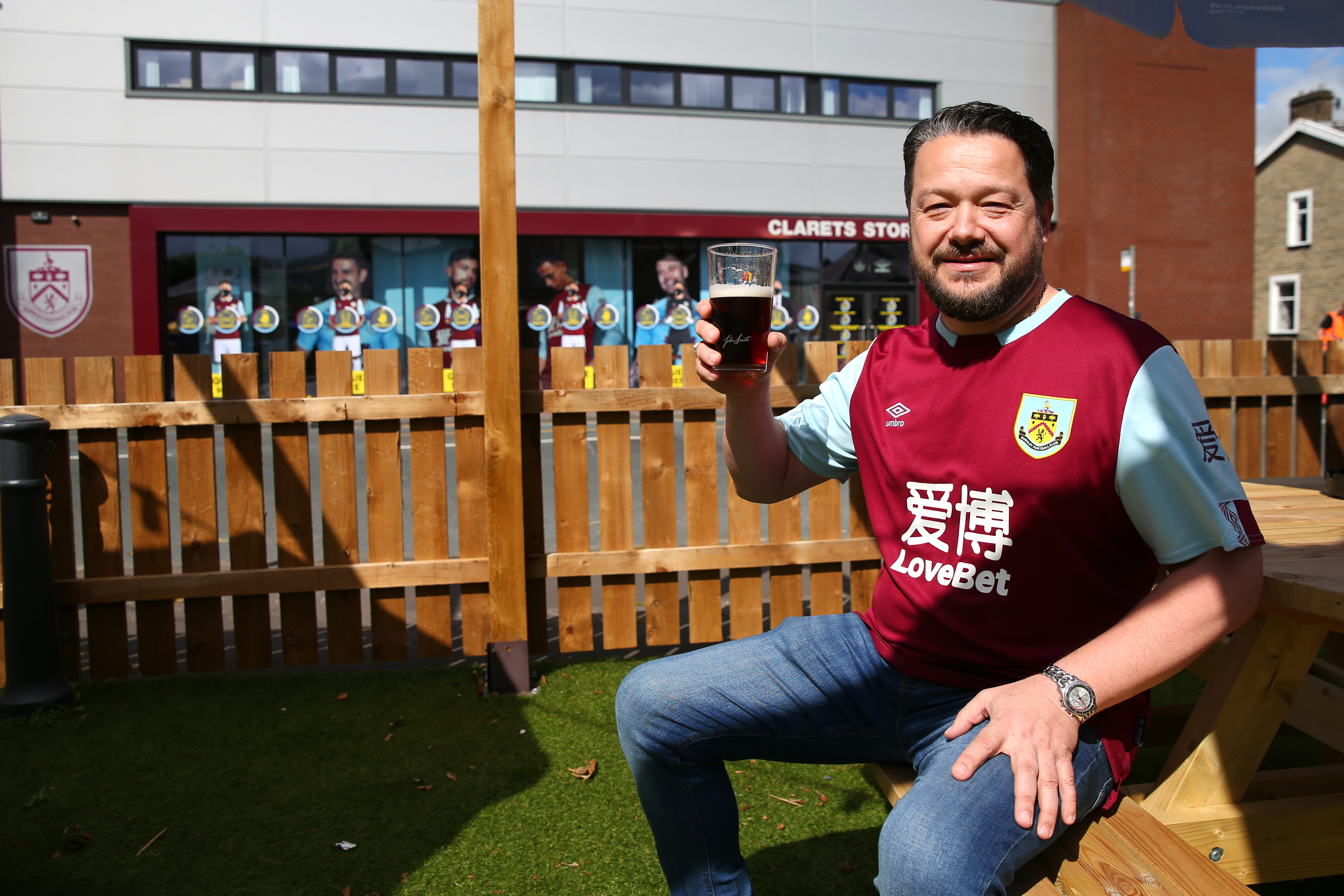 Burnley fan enjoys a beer at the pub outside the stadium prior to a match - Premier League