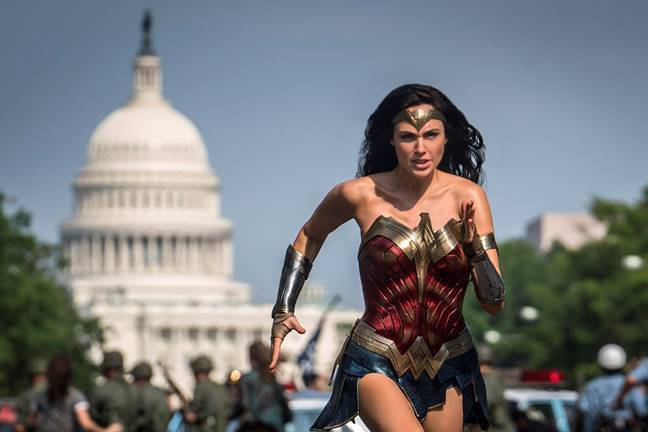 Wonder Woman running down a street in Washington, DC, with the Capitol building in the background.