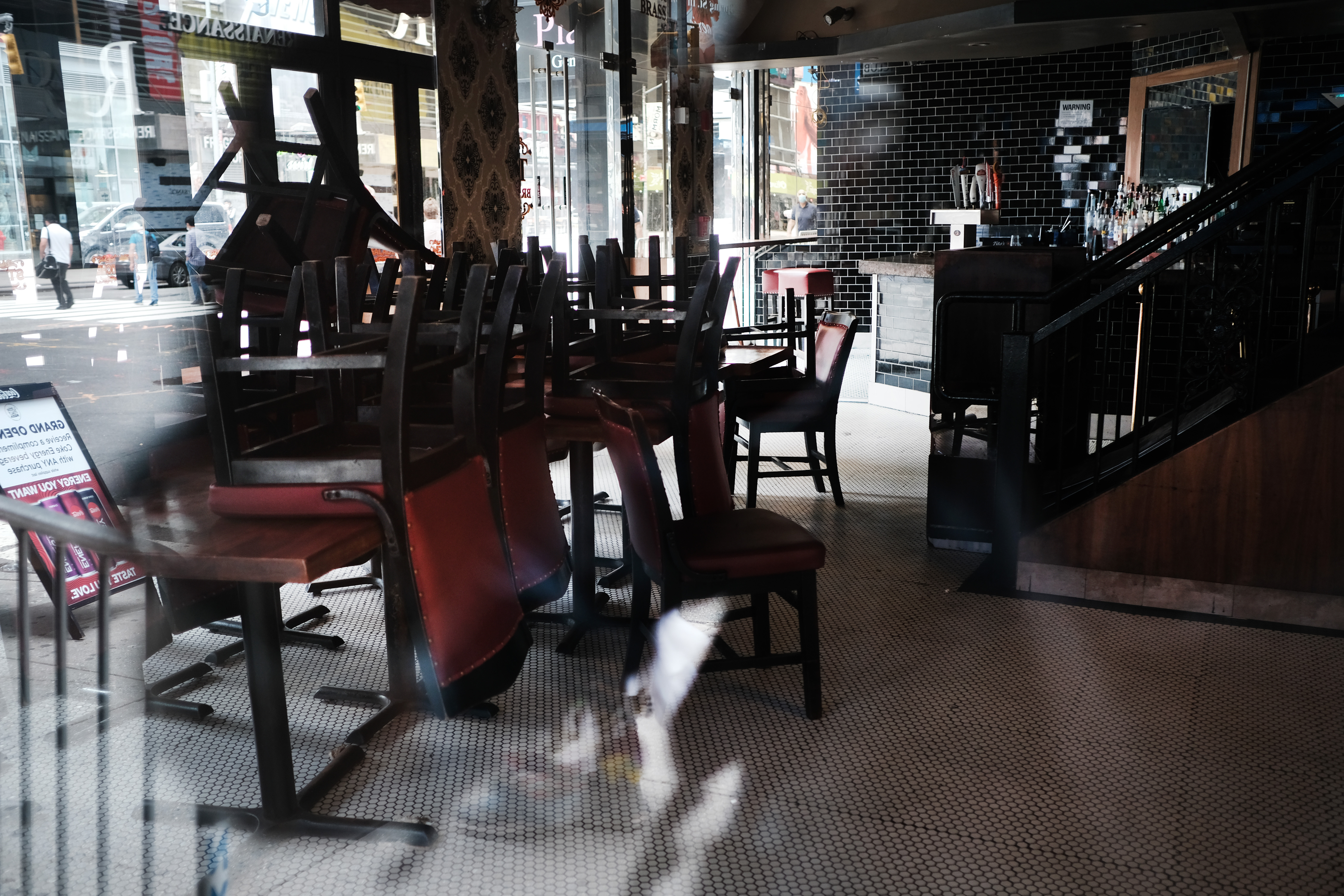 Chairs piled up on indoor tables at a restaurant.