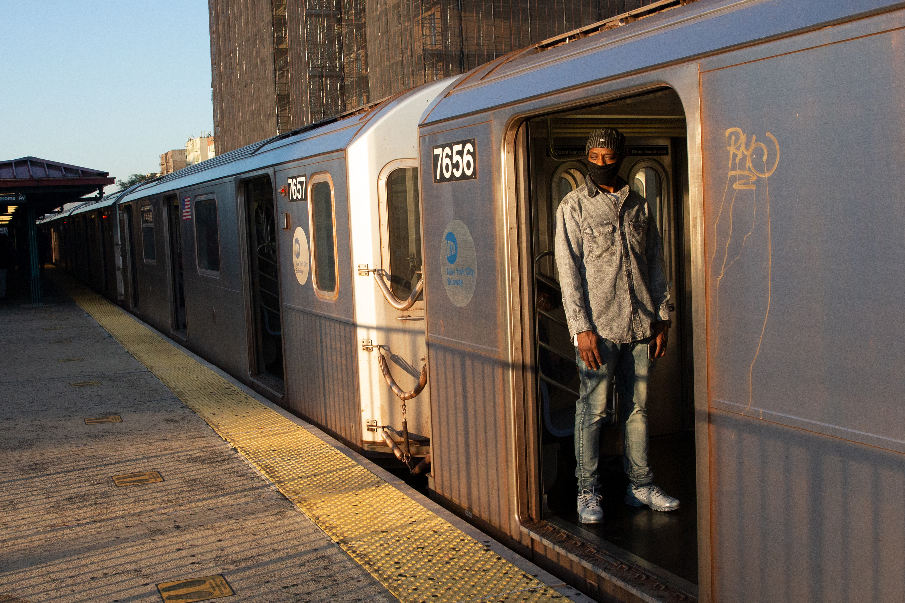 People take a 4 train in the Bronx during the morning commute, Oct. 1, 2020.