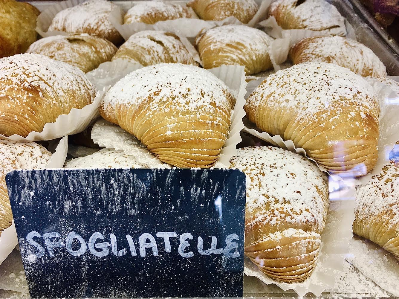 A tray of sfogliatelle, pastry that is shaped a bit like a lobster’s tail. Sfogliatella means “thin leaf” or “thin layer” in Italian.