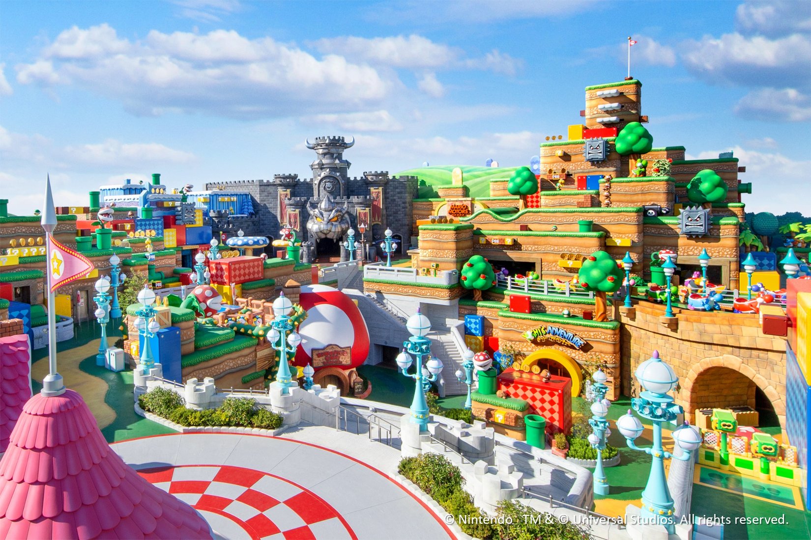 a panoramic view of super nintendo world including peach’s castle